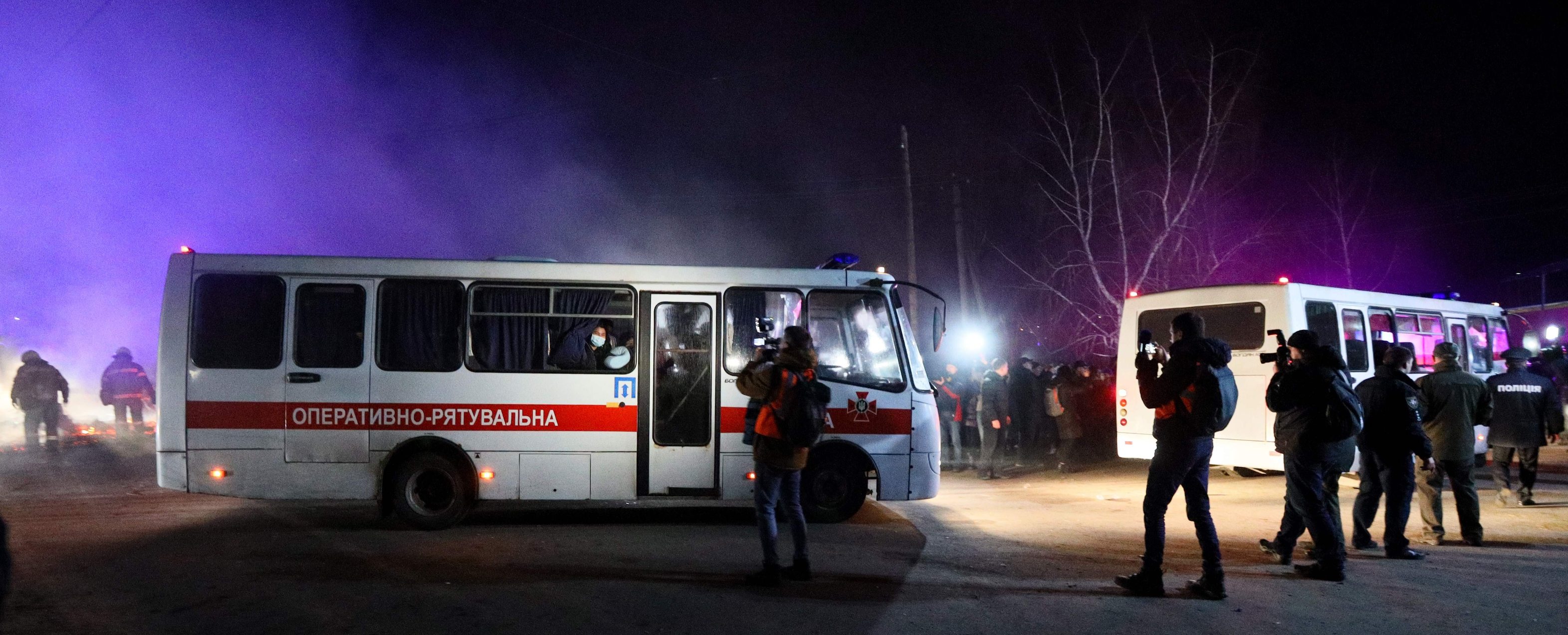 Buses carrying evacuees from coronavirus-hit China drive to a medical facility in the settlement of Novi Sanzhary on February 20, 2020. (Photo by STR / AFP)