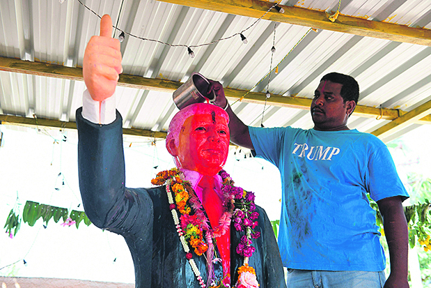 Farmer Bussa Krishna, 33, performs rituals on a statue of US President Donald Trump, at his residence in Jangaon district, some 120 km from Hyderabad on February 17, 2020, ahead of the visit of US President Donald Trump to India. - Trump and his wife Melania will start a high profile two-day visit to India in Ahmedabad, the home fief of Prime Minister Narendra Modi, on February 24. (Photo by NOAH SEELAM / AFP)