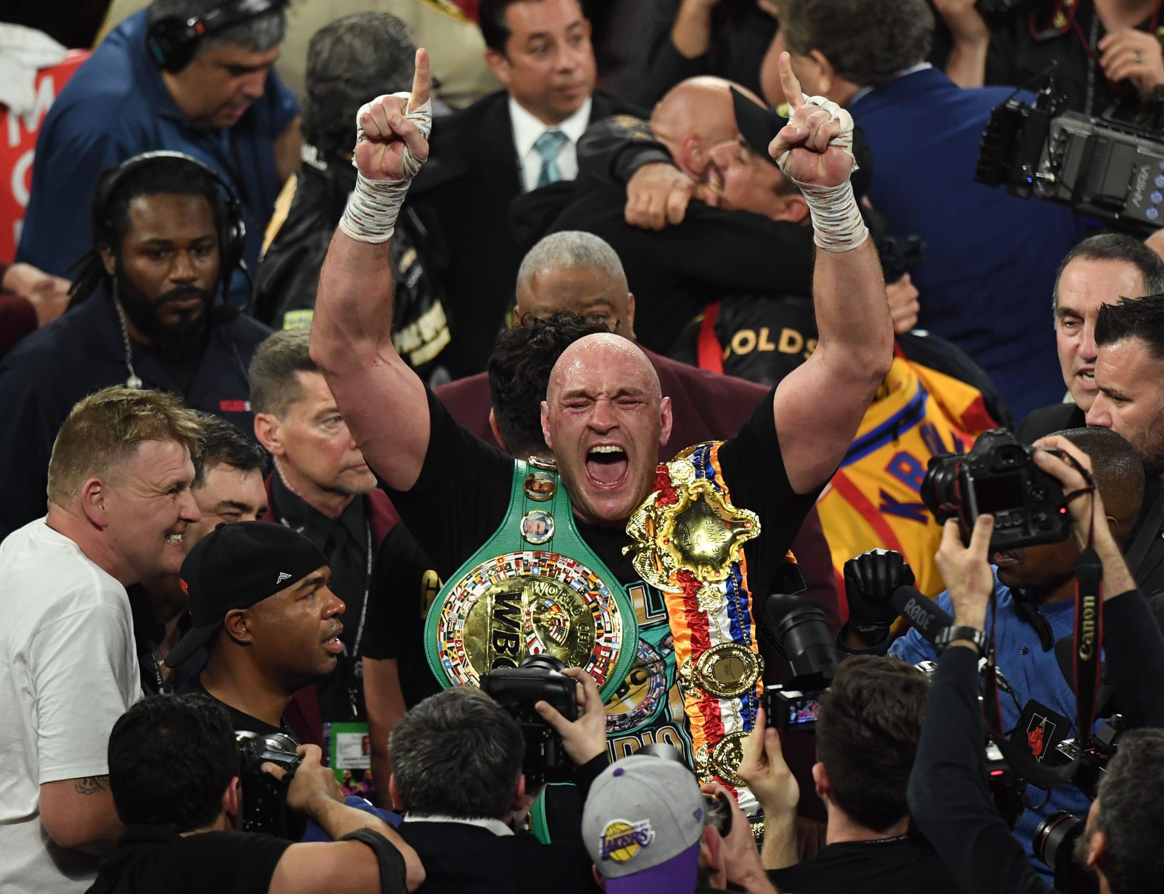 British boxer Tyson Fury celebrates after defeating US boxer Deontay Wilder in the seventh round during their World Boxing Council (WBC) Heavyweight Championship Title boxing match at the MGM Grand Garden Arena in Las Vegas on February 22, 2020. (Photo by Mark RALSTON / AFP)