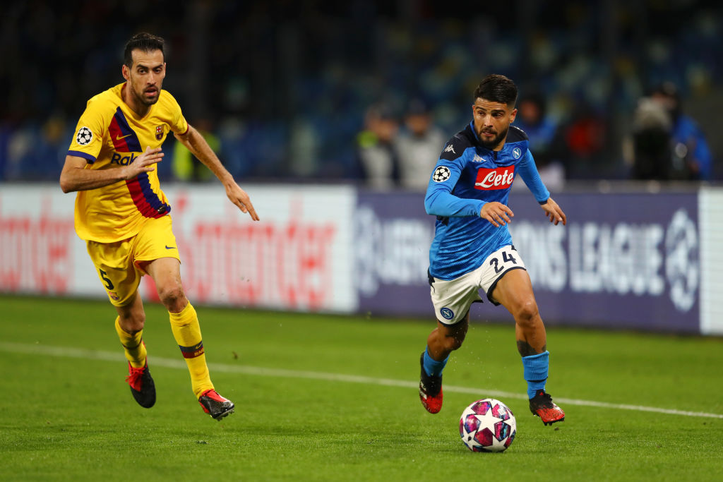 NAPLES, ITALY - FEBRUARY 25: Lorenzo Insigne of SSC Napoli runs with the ball while challenged by Sergio Busquets of FC Barcelona during the UEFA Champions League round of 16 first leg match between SSC Napoli and FC Barcelona at Stadio San Paolo on February 25, 2020 in Naples, Italy. (Photo by Michael Steele/Getty Images)