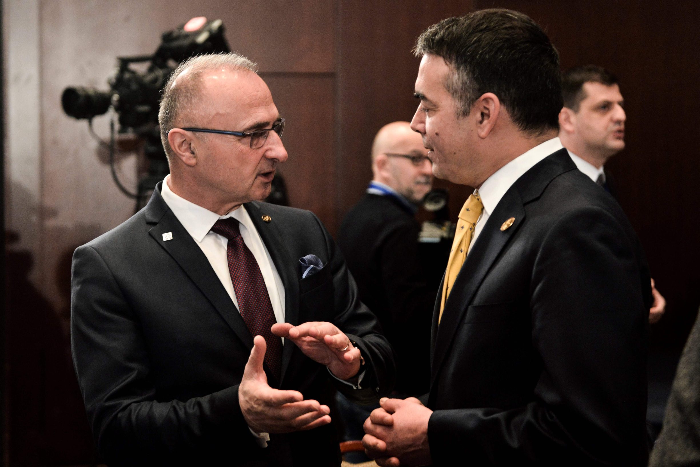 Foreign minister of North Macedonia Nikola Dimitrov (R) speaks with his counterpart of Croatia Gordan Grlic (L) during the high-level conference 