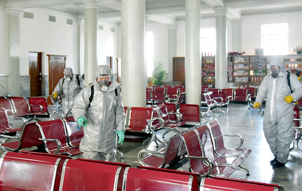 This undated picture released from North Korea's official Korean Central News Agency (KCNA) on February 15, 2020 shows people in protective suits spraying disinfectant at an undisclosed location in North Korea, amid concerns of the COVID-19 coronavirus outbreak. - The death toll from China's new coronavirus epidemic jumped past 1,500 on February 15 but new infections fell following a mid-week surge caused by a change in the way cases are counted. (Photo by STR / KCNA VIA KNS / AFP) / - South Korea OUT / REPUBLIC OF KOREA OUT   ---EDITORS NOTE--- RESTRICTED TO EDITORIAL USE - MANDATORY CREDIT 