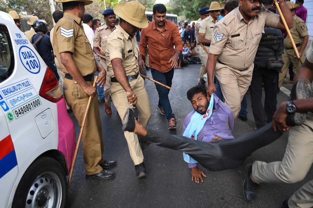 A student member of the Campus Front of India is taken into police custody while resisting arrest for protesting in the prohibited, high security zone near the Karnataka Governor's house, also known as the Raj Bhavan, in Bangalore on February 27, 2020. - The students were protesting against the recent unrest in wake of violent clashes between protesters and supporters of India's controversial citizenship law in New Delhi that have claimed so far claimed lives of 33 people in the capital in the past four days. (Photo by Manjunath KIRAN / AFP)