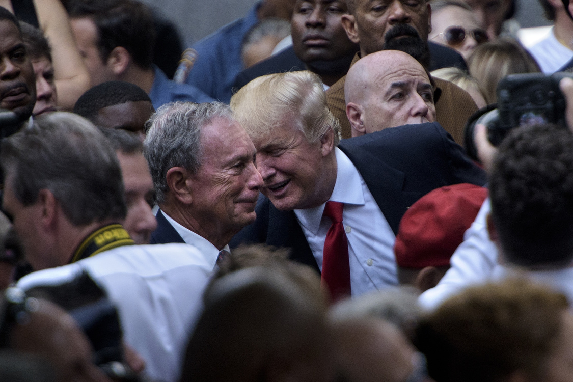 US Republican presidential nominee Donald Trump speaks to former New York City Mayor Michael Bloomberg  during a memorial service at the National 9/11 Memorial September 11, 2016 in New York. - The United States on Sunday commemorated the 15th anniversary of the 9/11 attacks. (Photo by Brendan Smialowski / AFP)