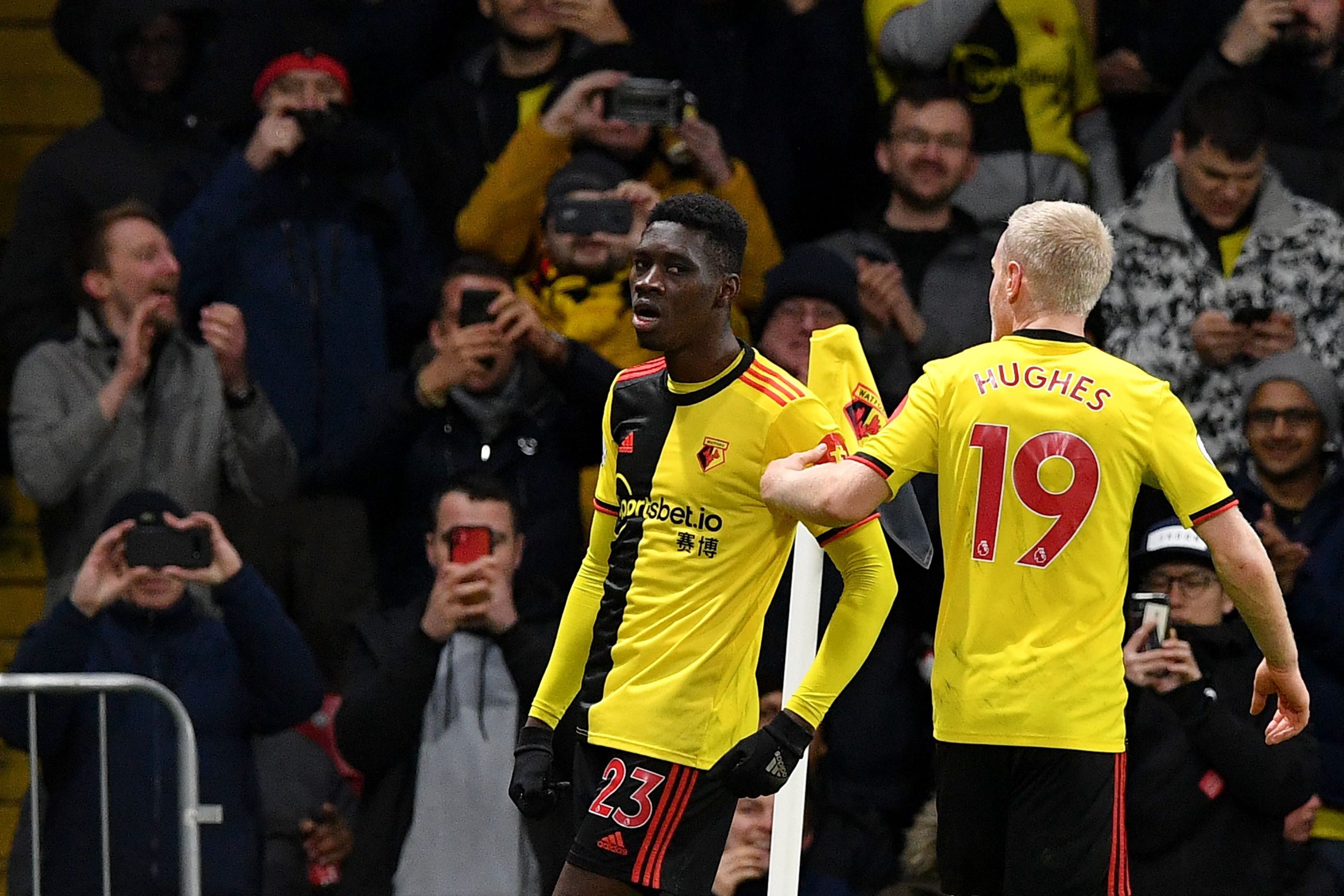 Watford's Senegalese midfielder Ismaila Sarr (L) celebrates with Watford's English midfielder Will Hughes after he scores his team's second goal past Liverpool's Brazilian goalkeeper Alisson Becker during the English Premier League football match between Watford and Liverpool at Vicarage Road Stadium in Watford, north of London on February 29, 2020. (Photo by Justin TALLIS / AFP) / RESTRICTED TO EDITORIAL USE. No use with unauthorized audio, video, data, fixture lists, club/league logos or 'live' services. Online in-match use limited to 120 images. An additional 40 images may be used in extra time. No video emulation. Social media in-match use limited to 120 images. An additional 40 images may be used in extra time. No use in betting publications, games or single club/league/player publications. / 