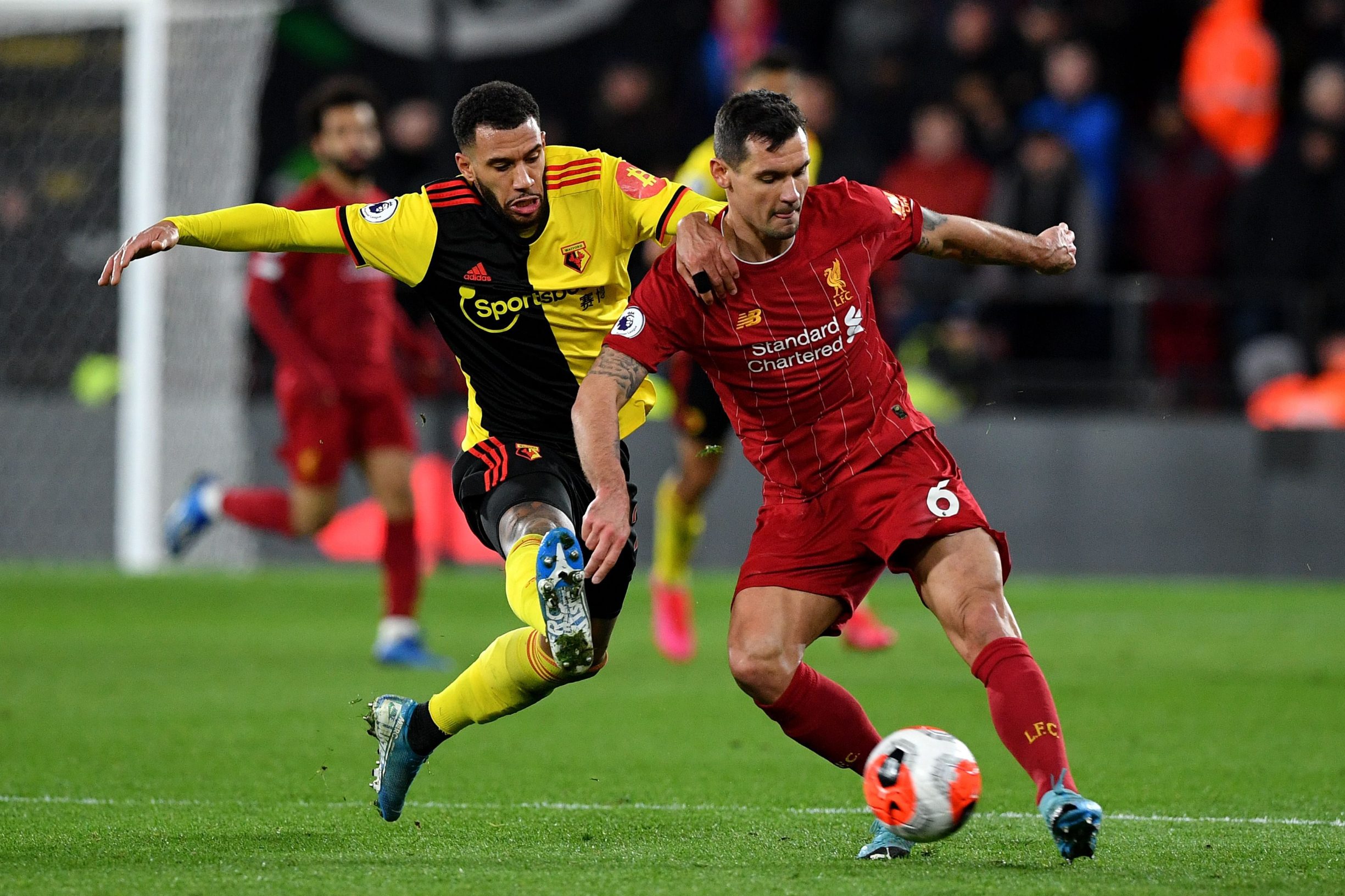 Watford's French midfielder Etienne Capoue (L) and Liverpool's Croatian defender Dejan Lovren vie for the ball during the English Premier League football match between Watford and Liverpool at Vicarage Road Stadium in Watford, north of London on February 29, 2020. (Photo by Justin TALLIS / AFP) / RESTRICTED TO EDITORIAL USE. No use with unauthorized audio, video, data, fixture lists, club/league logos or 'live' services. Online in-match use limited to 120 images. An additional 40 images may be used in extra time. No video emulation. Social media in-match use limited to 120 images. An additional 40 images may be used in extra time. No use in betting publications, games or single club/league/player publications. / 