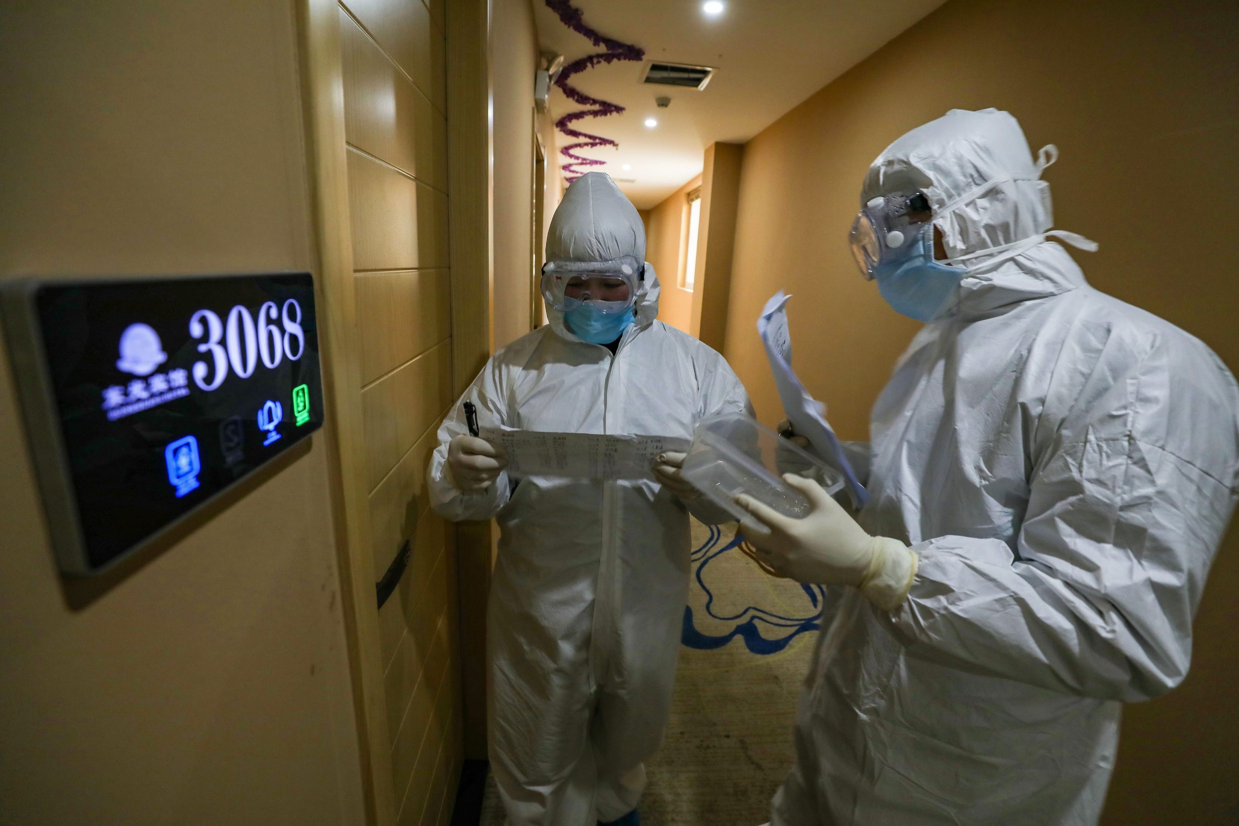 This photo taken on February 3, 2020 shows medical staff members on their rounds at a quarantine zone in Wuhan, the epicentre of the new coronavirus outbreak, in China's central Hubei province. - The number of total infections in China's coronavirus outbreak has passed 20,400 nationwide with 3,235 new cases confirmed, the National Health Commission said on February 4. (Photo by STR / AFP) / China OUT