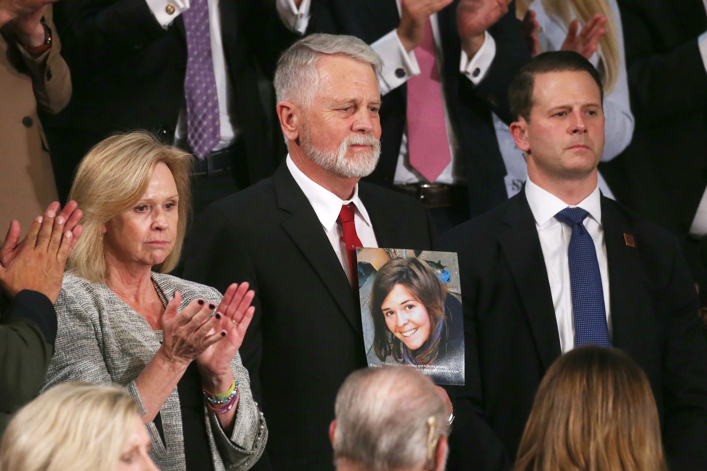 WASHINGTON, DC - FEBRUARY 04: Carl Mueller (C) holds a photo of his daughter, Kayla, as his wife Marsha (L) looks on during the State of the Union address in the chamber of the U.S. House of Representatives on February 04, 2020 in Washington, DC. President Trump delivers his third State of the Union to the nation the night before the U.S. Senate is set to vote in his impeachment trial.   Mario Tama/Getty Images/AFP
== FOR NEWSPAPERS, INTERNET, TELCOS & TELEVISION USE ONLY ==