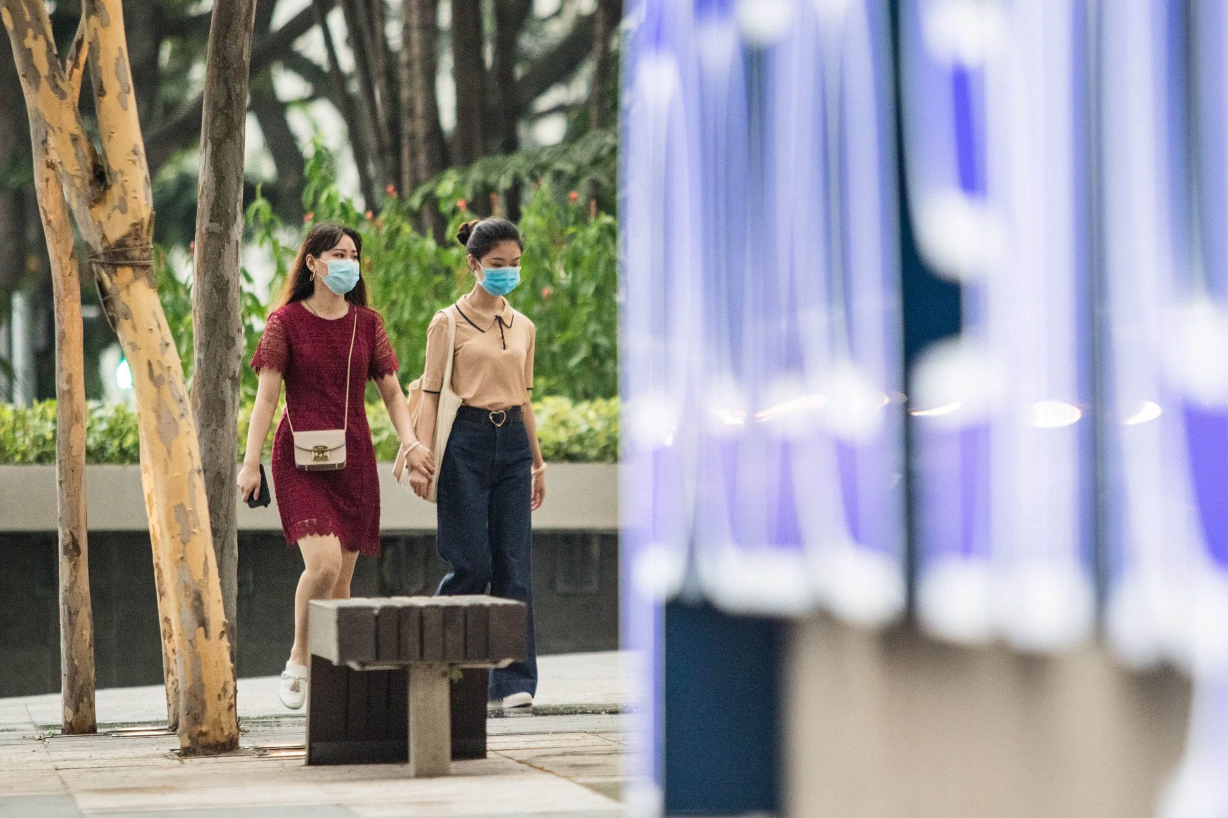 Women wear facemasks amid fears of the COVID-19 novel coronavirus in the Orchard Road shopping district in Singapore on March 10, 2020. (Photo by Louis KWOK / AFP)