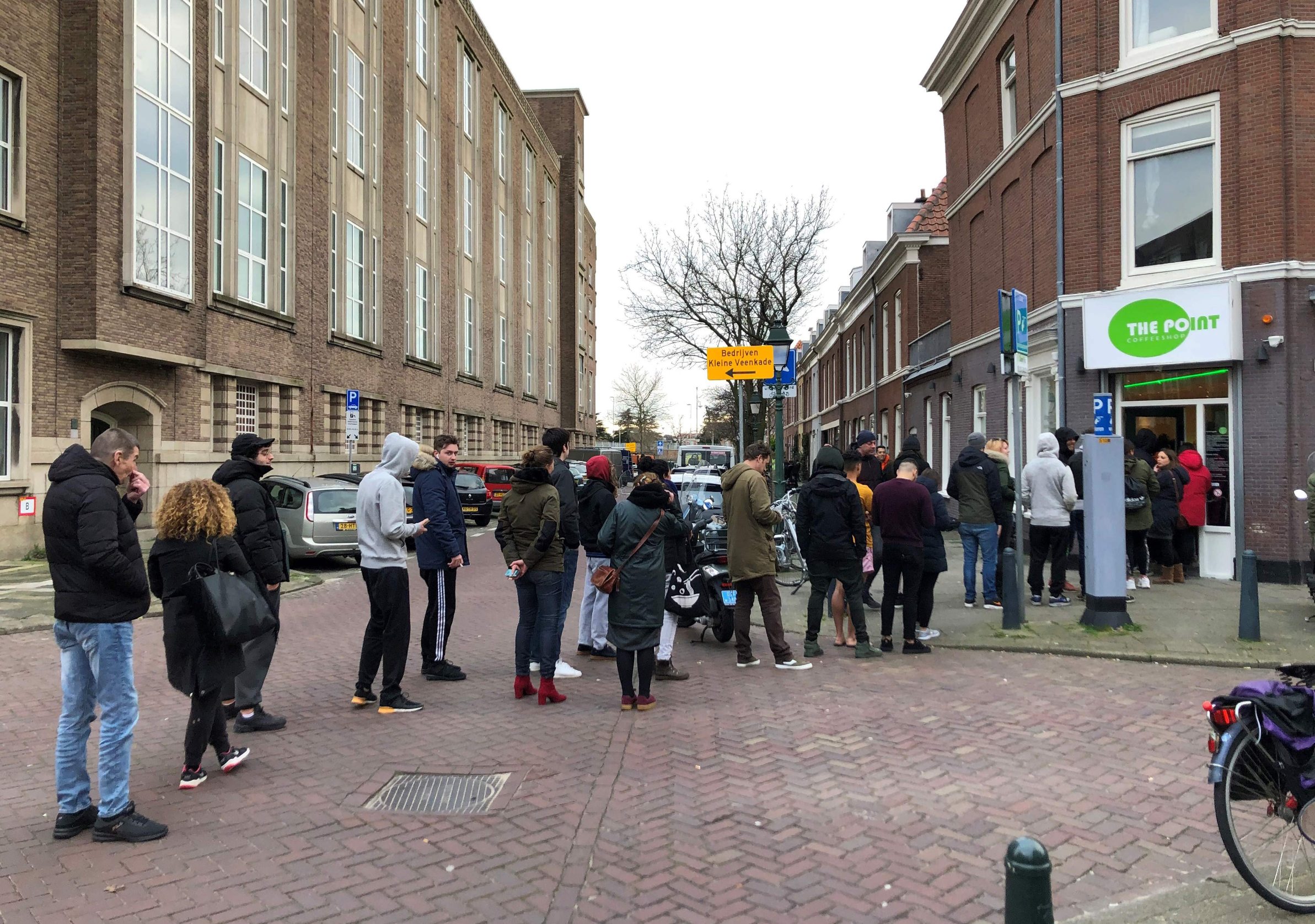 People queue outside a cannabis coffee shop on March 15, 2020, in the Hague, after the Dutch government ordered the closing of all schools, bars, restaurants, sex clubs and cannabis cafes in a bid to fight the spread of COVID-19, the new coronavirus. - Queues quickly built up at 
