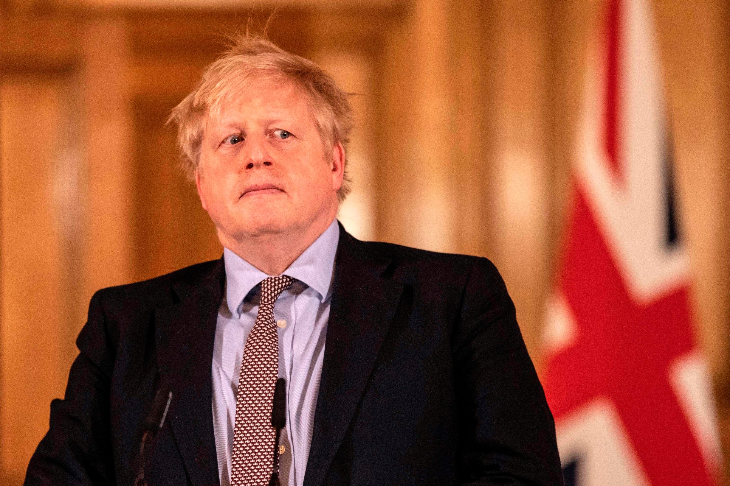 TOPSHOT - Prime Minister Boris Johnson gives a press conference on the ongoing COVID-19 situation in London on March 16, 2020. (Photo by Richard Pohle / POOL / AFP)