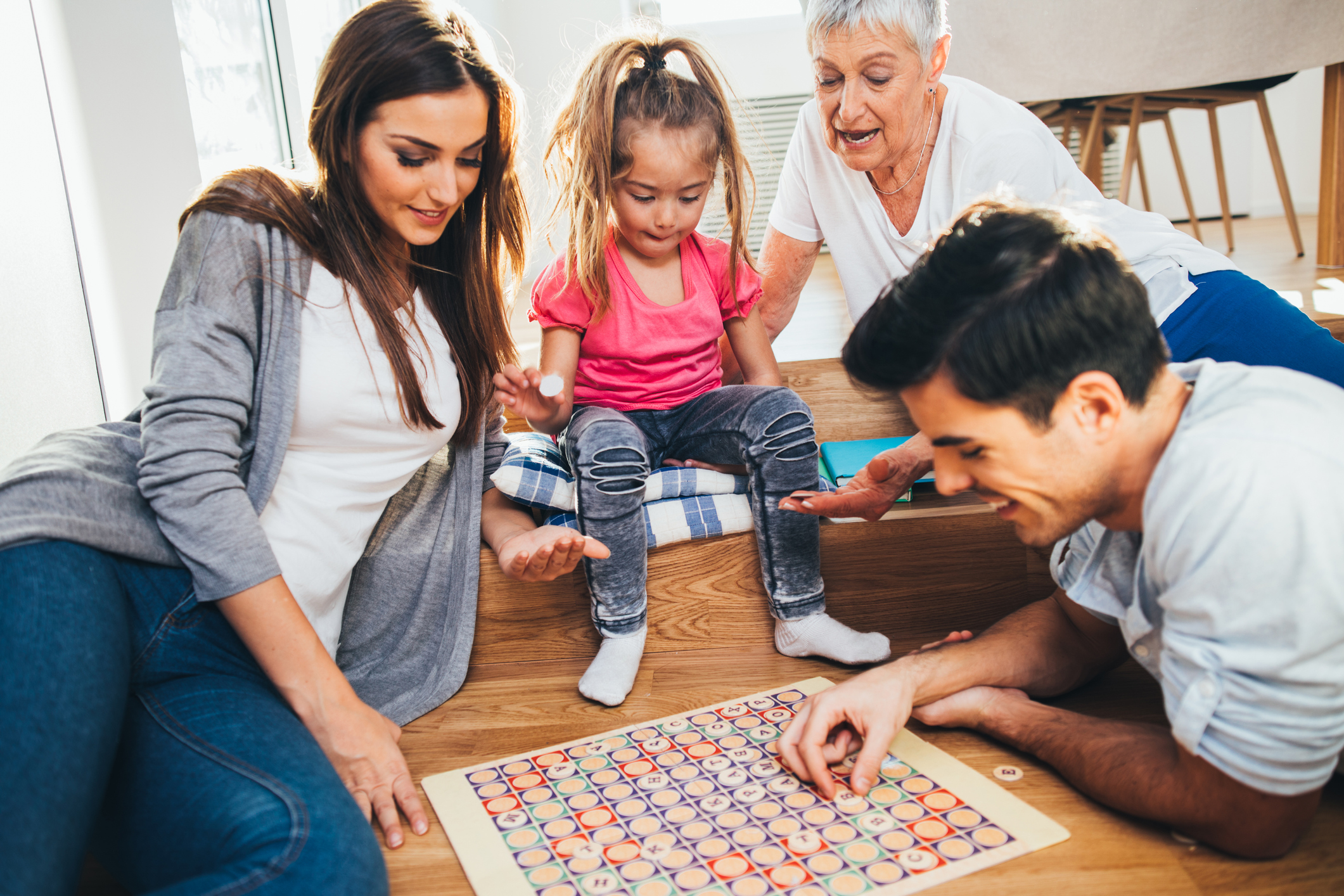 Three generation family playing a word game at home.