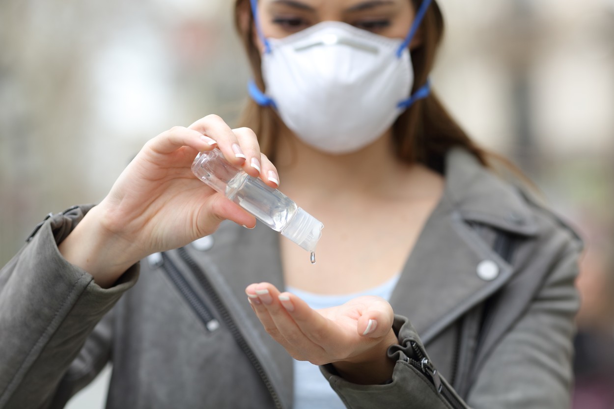 Close up front view of a woman with protective mask using hand sanitizer preventing contagion on street, Image: 505047561, License: Royalty-free, Restrictions: , Model Release: yes, Credit line: Antonio Guillen Fernández / Panthermedia / Profimedia