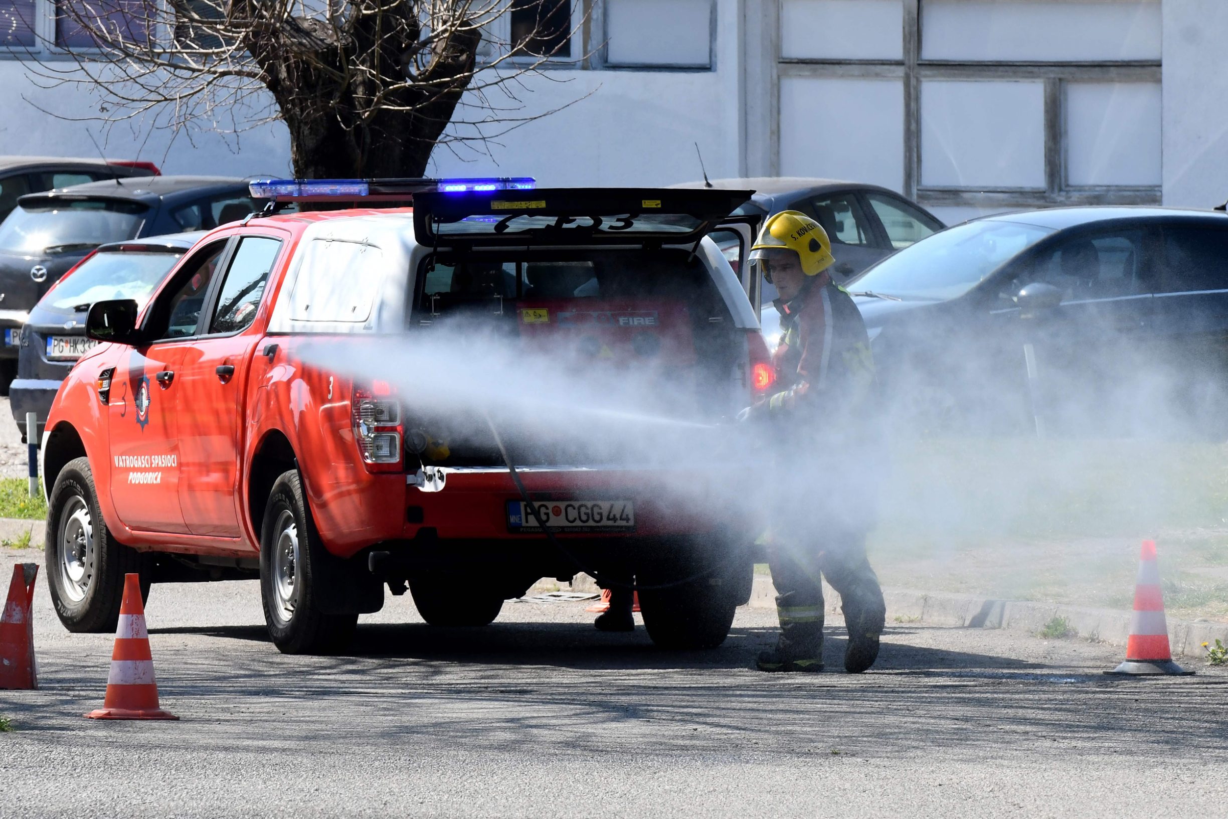 Montenegrin firefighters disinfect the entrance to the Medical center in capital Podgorica, on March 20, 2020, amid the outbreak of COVID-19, caused by the coronavirus. - Montenegro, which has detected 13 confirmed infections of COVID-19 so far, issued strict measures, including a closure of schools, ban on public gatherings, and restrictions of land and sea passenger transport. (Photo by Savo PRELEVIC / AFP)