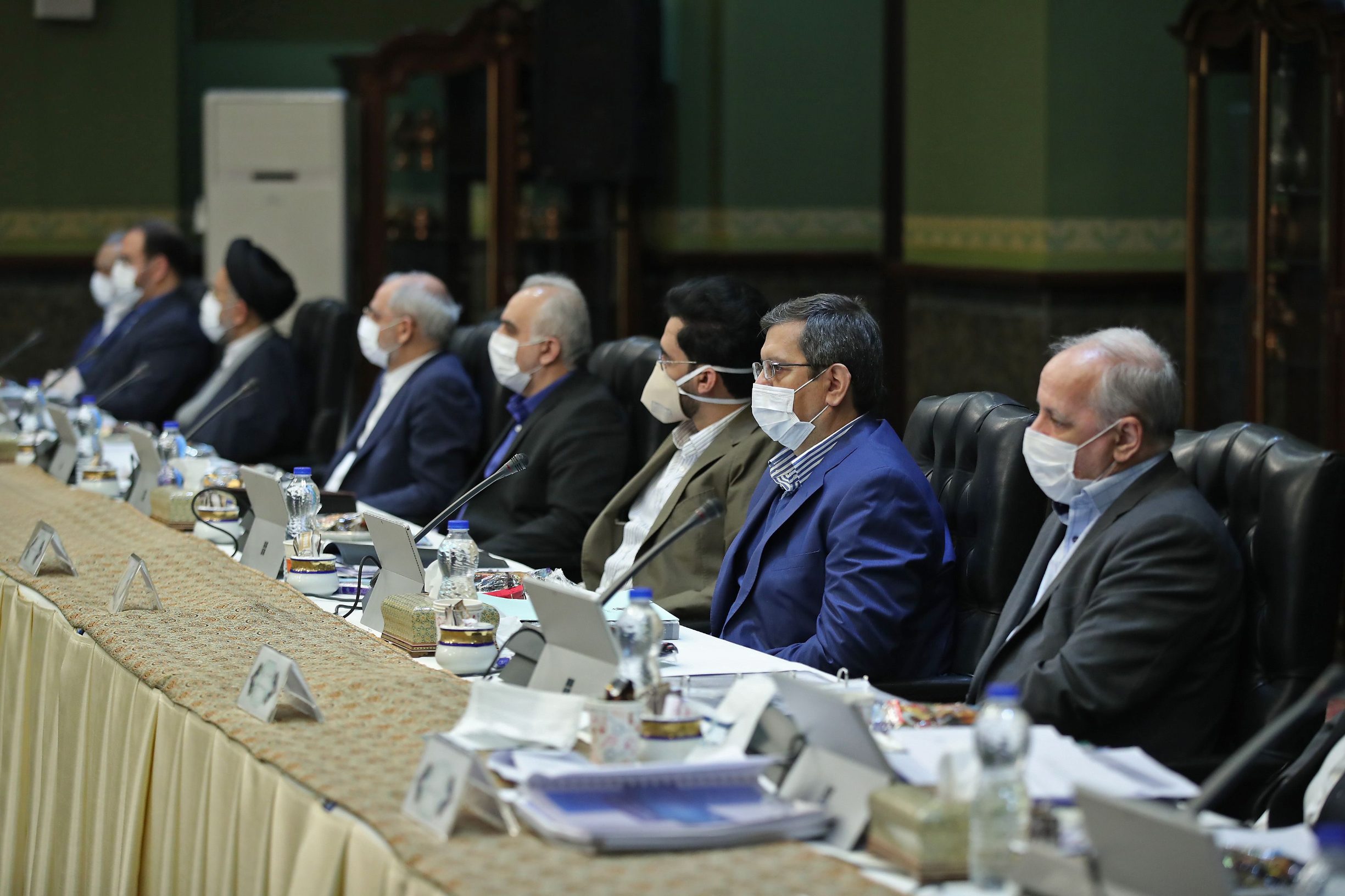 A handout picture provided by the Iranian presidency on March 25, 2020, shows Iranian cabinet members wearing protective masks during a cabinet session in the capital Tehran. - Iran will ban intercity travel within days as it finally gets tough with the coronavirus that has killed more than 2,000 people in one of the world's deadliest outbreaks, officials said Wednesday. (Photo by - / Iranian Presidency / AFP) / === RESTRICTED TO EDITORIAL USE - MANDATORY CREDIT 