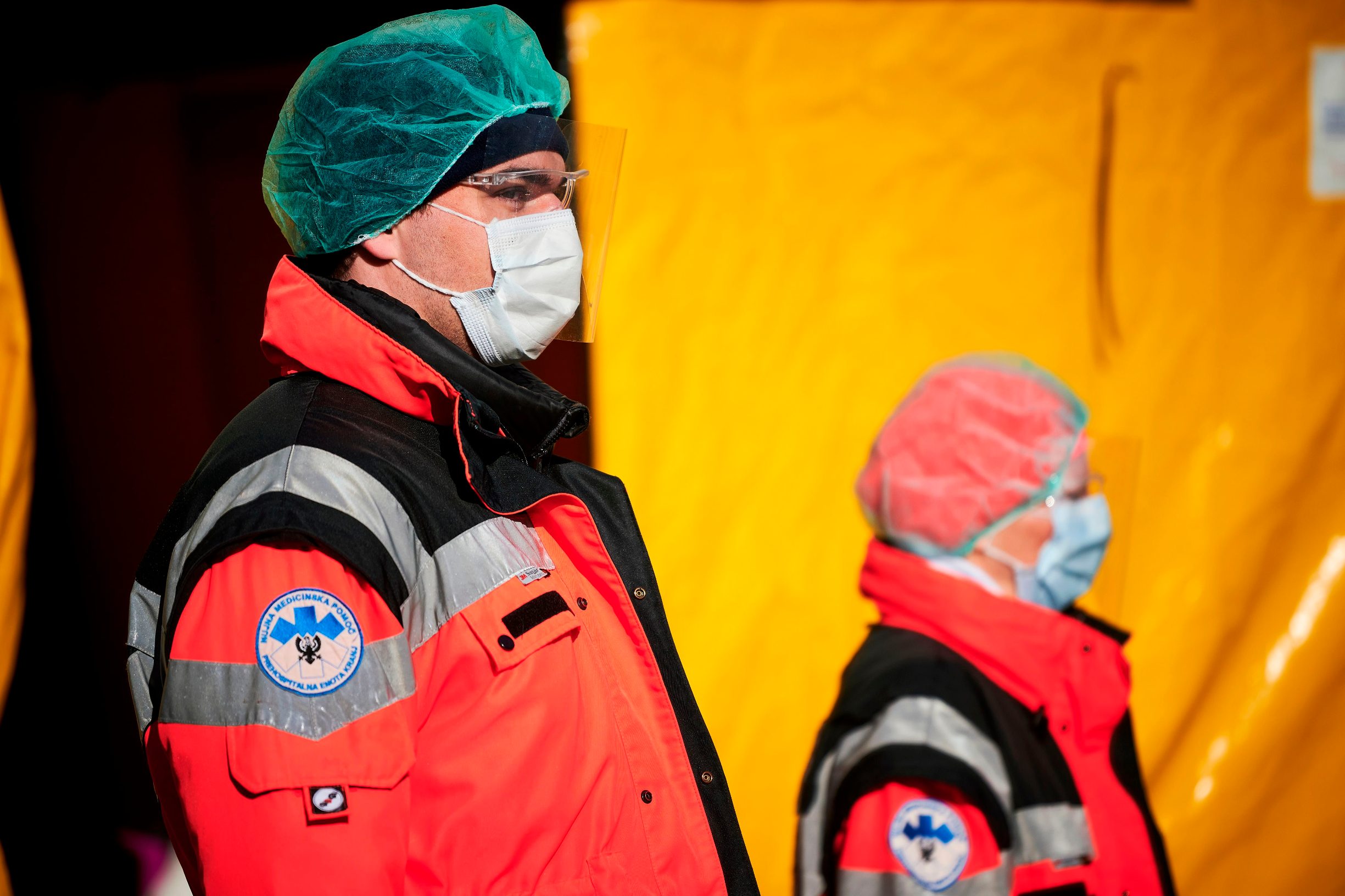 Medical workers stand in front of one of the entrances of the Community Health Centre in Kranj, Slovenia, on March 23, 2020 amid concerns over the spread of the COVID-19 coronavirus. (Photo by Jure Makovec / AFP)