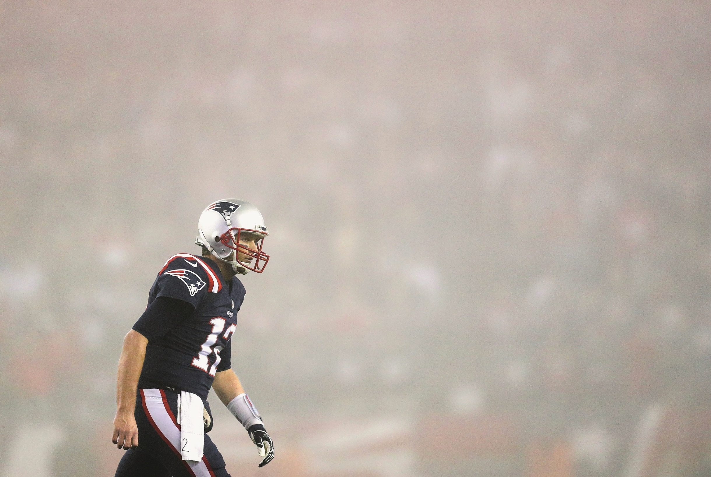 FOXBORO, MASSACHUSETTS - OCTOBER 22:  Tom Brady #12 of the New England Patriots reacts as fog falls on the field during the fourth quarter of a game against the Atlanta Falcons at Gillette Stadium on October 22, 2017 in Foxboro, Massachusetts.  (Photo by Maddie Meyer/Getty Images)