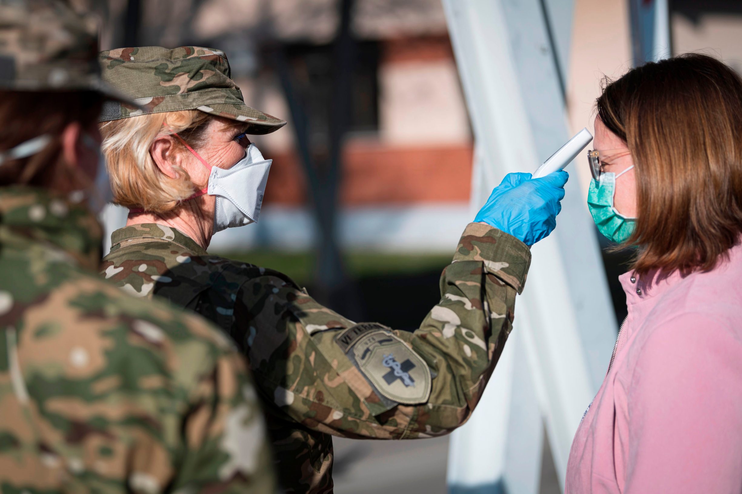 Members of Medical Unit of Slovenian Army measure body temperature prior entering the facilities for treatment of coronavirus patients