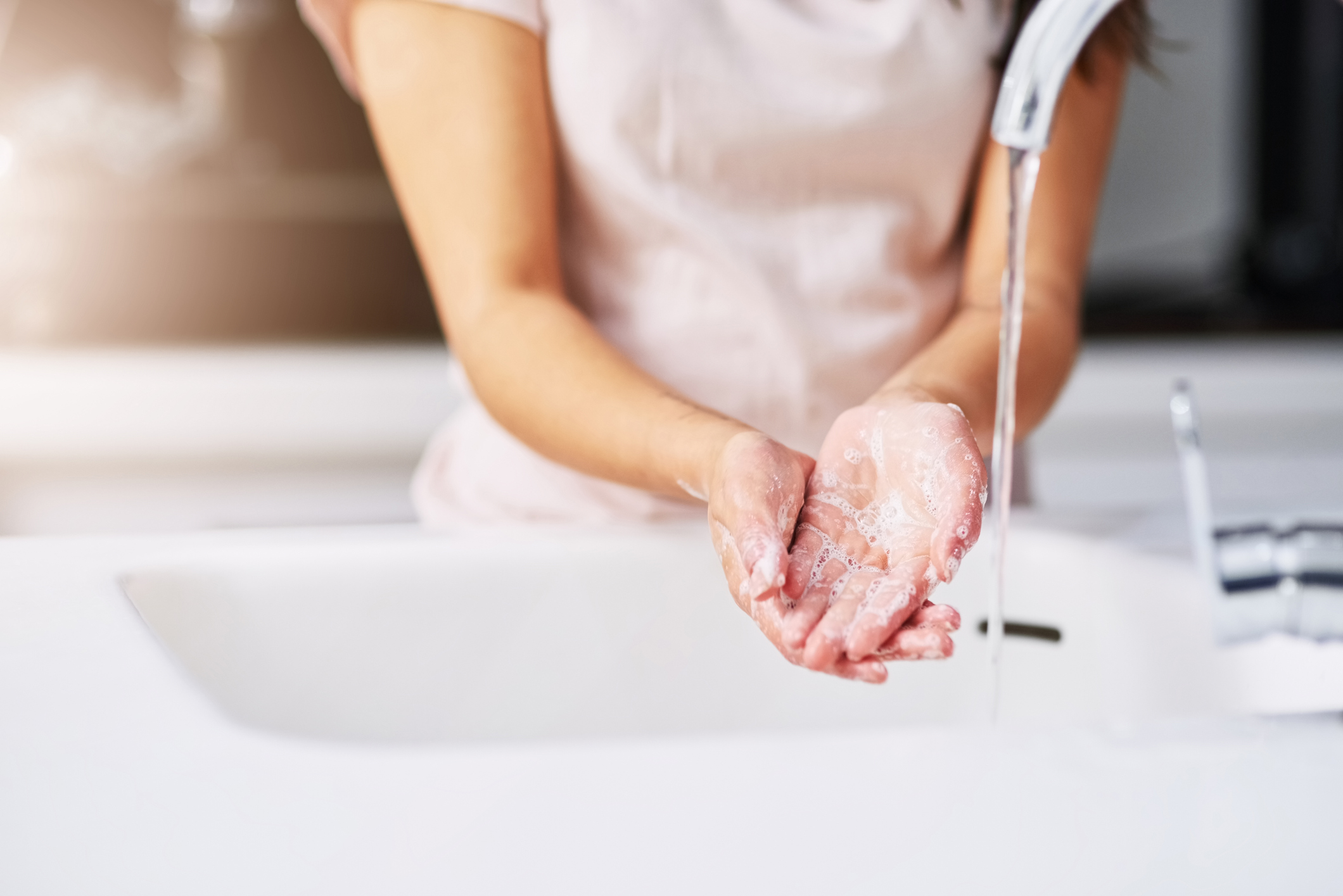 Closeup shot of an unrecognizable woman washing her hands
