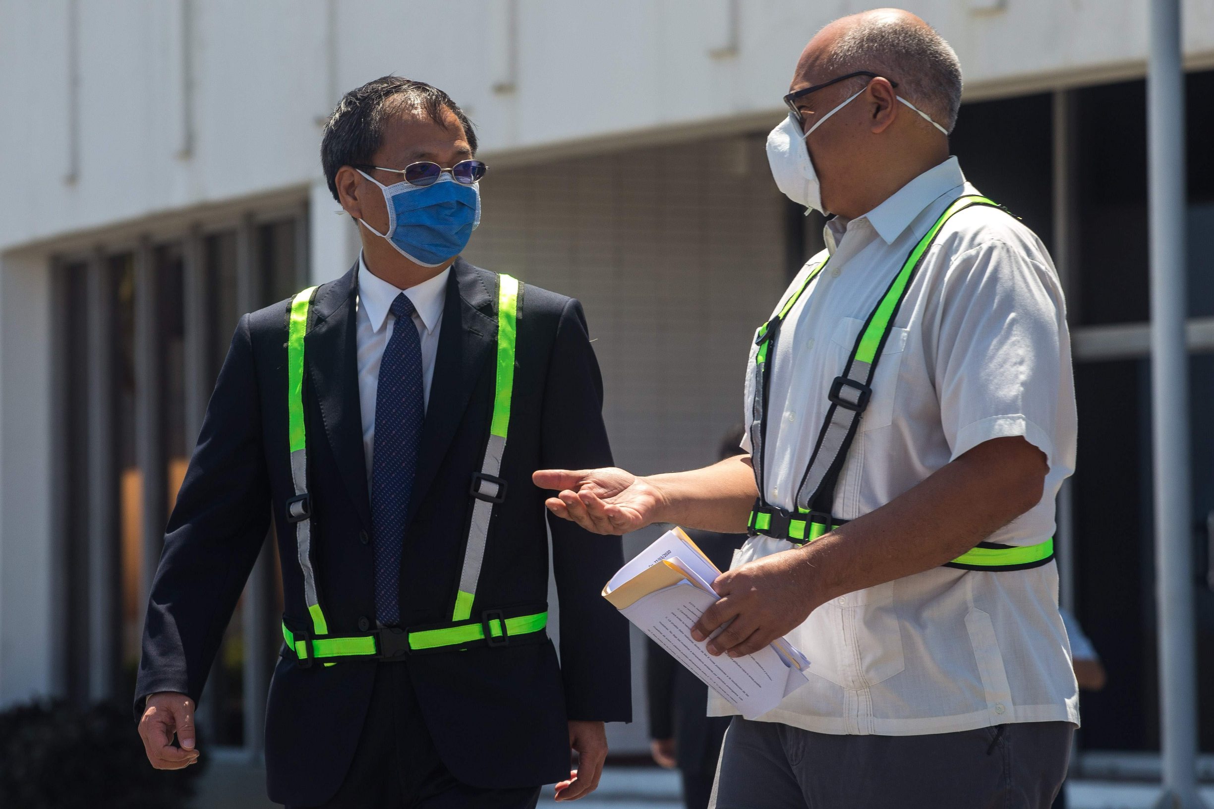 Venezuela's Health Minister Carlos Alvarado Gonzalez (R) speaks with the People's Republic of China's ambassador to Venezuela, Li Baorong (L) -both wearing face masks as a preventive measure against the spread of coronavirus, COVID-19- during the arrival of a 55-ton shipment of humanitarian aid and medical equipment sent from China for the fight against the COVID-19, at the Simon Bolivar International Airport in Maiquetia, Vargas state, Venezuela on March 28, 2020. (Photo by Cristian Hernandez / AFP)