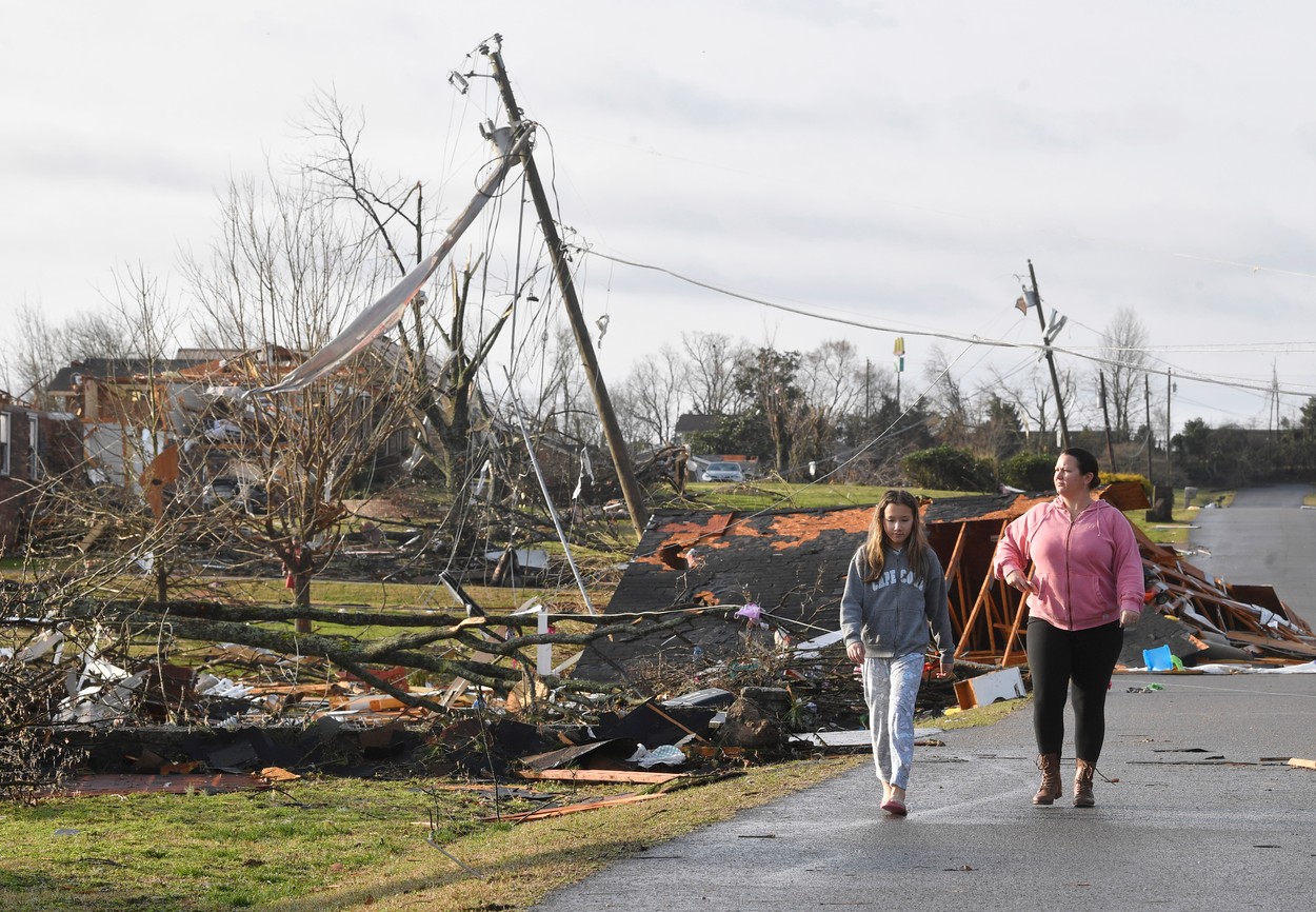 Mar 3, 2020; Nashville, TN; Aubrey and Jennifer Nguyen walk down Barrett Drive in Mt. Juliet after a tornado touched down Tuesday, March 3, 2020 in Middle Tennessee., Image: 502772712, License: Rights-managed, Restrictions: *** World Rights ***, Model Release: no, Credit line: USA TODAY Network / ddp USA / Profimedia