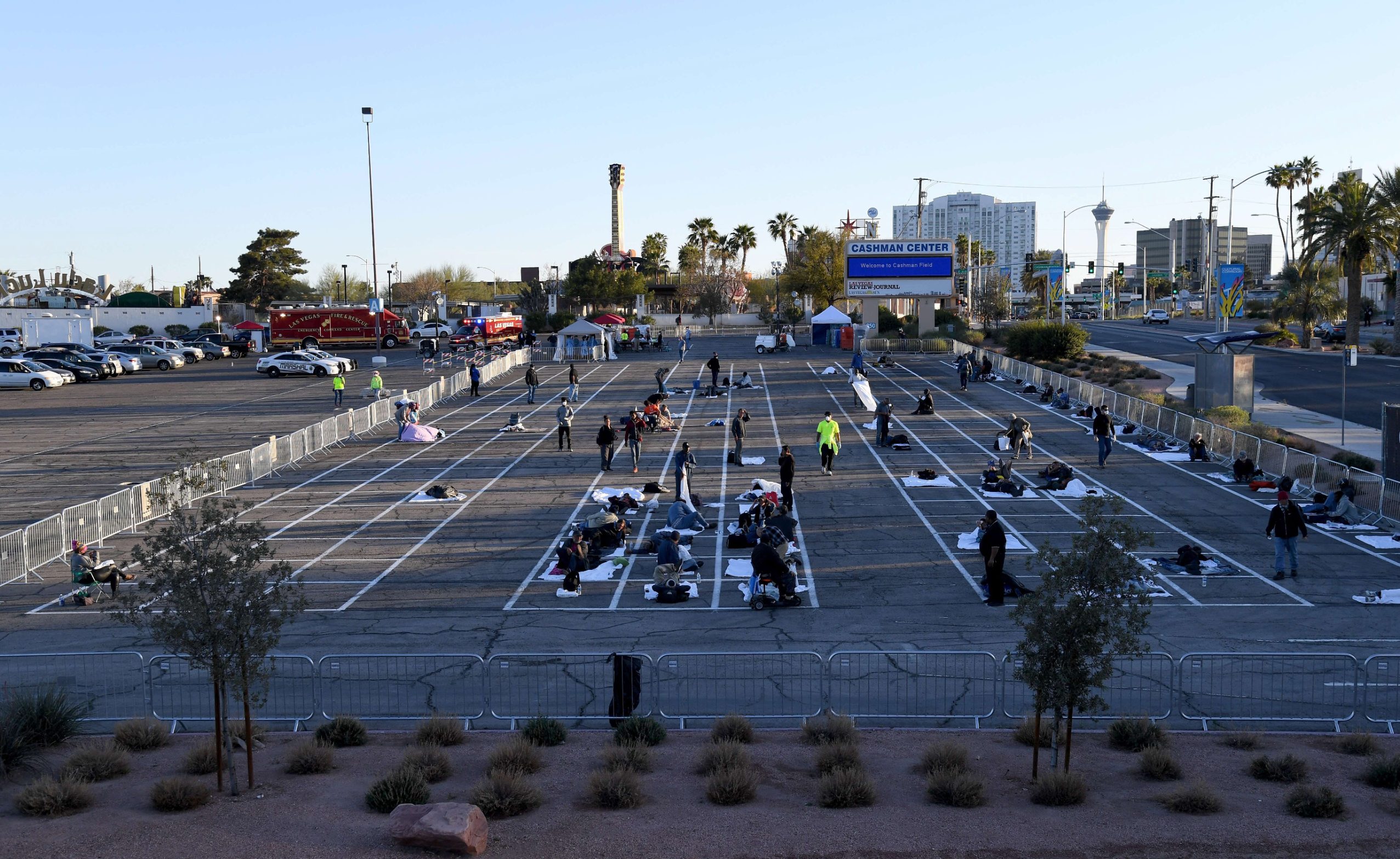 LAS VEGAS, NEVADA - MARCH 30: People arrive at a temporary homeless shelter set up in a parking lot at Cashman Center on March 30, 2020 in Las Vegas, Nevada. Catholic Charities of Southern Nevada was closed last week after a homeless man who used their services tested positive for the coronavirus, leaving about 500 people with no overnight shelter. The city of Las Vegas, Clark County and local homeless providers plan to operate the shelter through April 3rd when it is anticipated that the Catholic Charities facility will be back open. The city is also reserving the building spaces at Cashman Center in case of an overflow of hospital patients. The World Health Organization declared the coronavirus (COVID-19) a global pandemic on March 11th.   Ethan Miller/Getty Images/AFP
== FOR NEWSPAPERS, INTERNET, TELCOS & TELEVISION USE ONLY ==