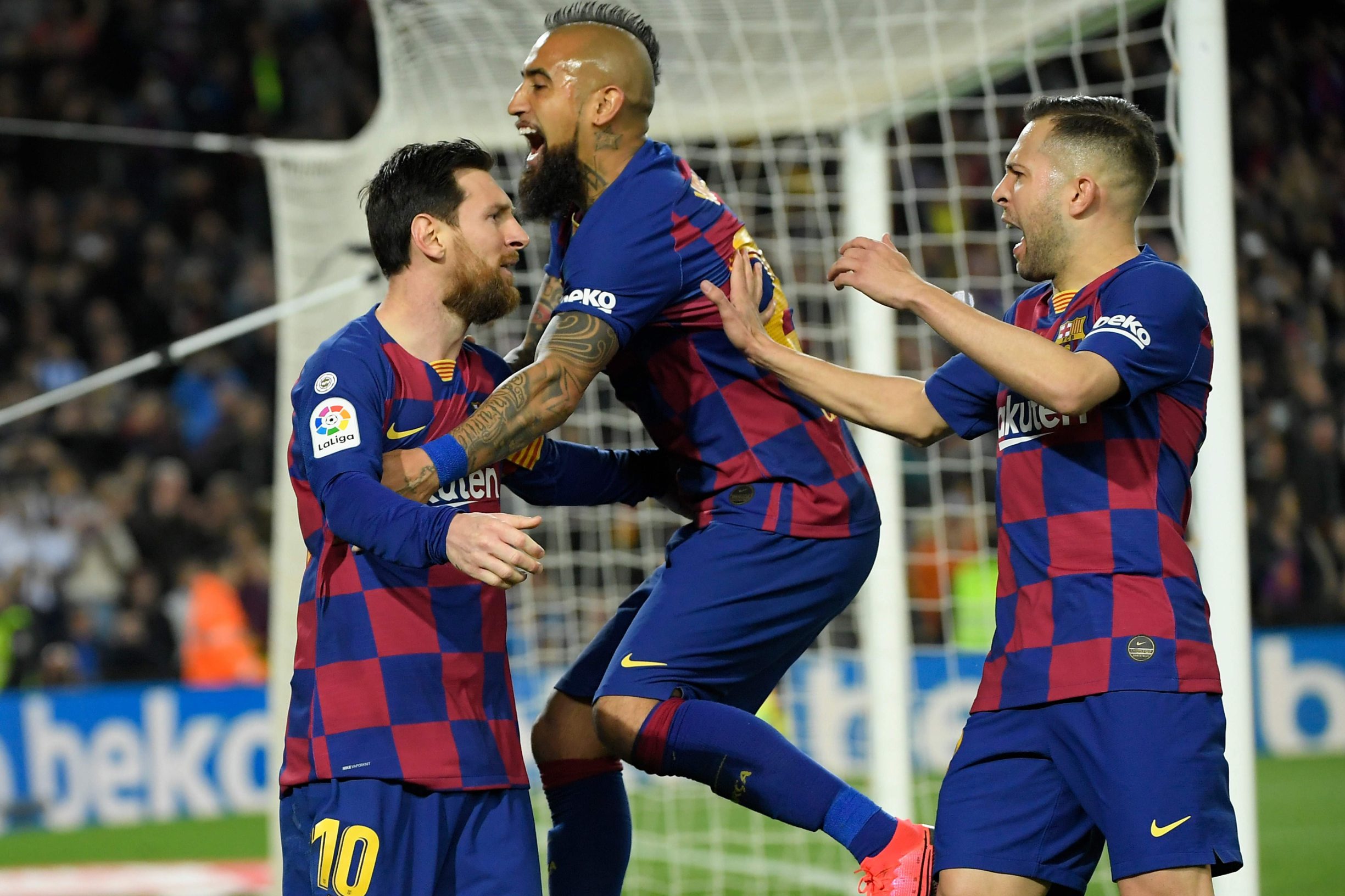 Barcelona's Argentine forward Lionel Messi (L) celebrates with Barcelona's Chilean midfielder Arturo Vidal and Barcelona's Spanish defender Jordi Alba after scoring a goal during the Spanish league football match between FC Barcelona and Real Sociedad at the Camp Nou stadium in Barcelona on March 7, 2020. (Photo by LLUIS GENE / AFP)
