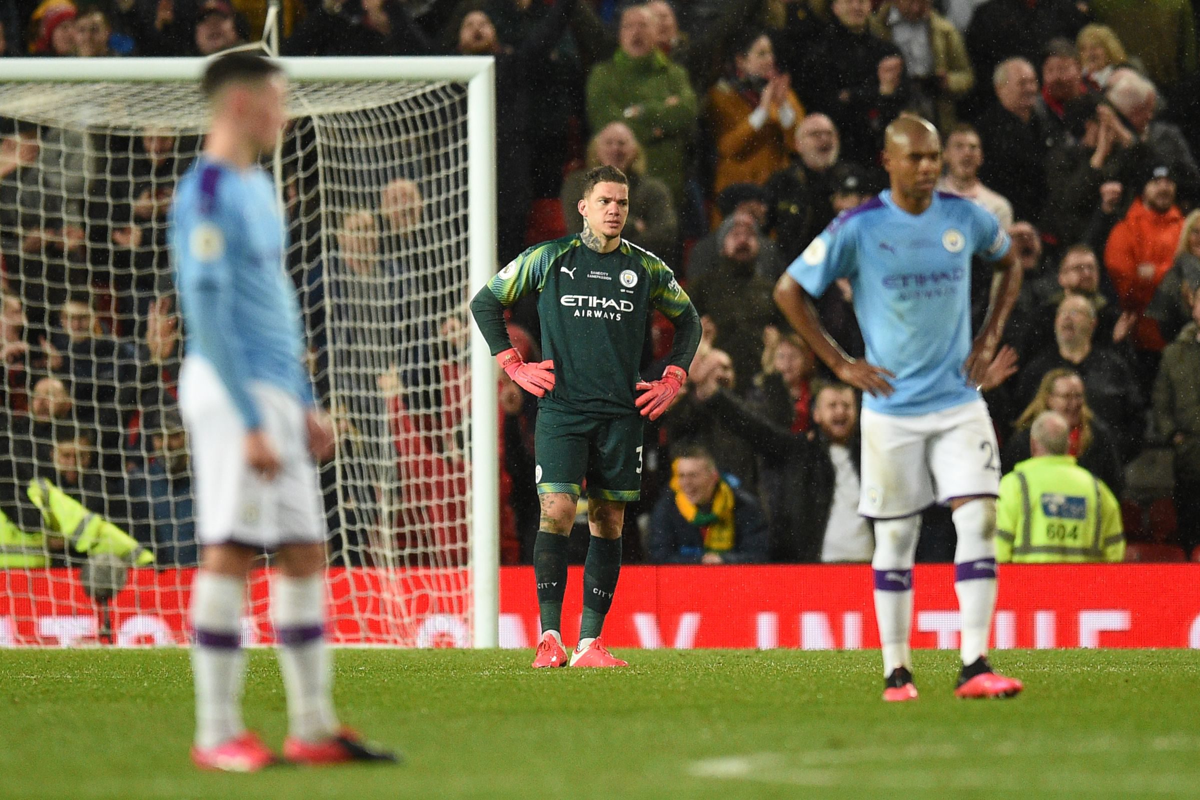 Manchester City's Brazilian goalkeeper Ederson (C) reacts during the English Premier League football match between Manchester United and Manchester City at Old Trafford in Manchester, north west England, on March 8, 2020. (Photo by Oli SCARFF / AFP) / RESTRICTED TO EDITORIAL USE. No use with unauthorized audio, video, data, fixture lists, club/league logos or 'live' services. Online in-match use limited to 120 images. An additional 40 images may be used in extra time. No video emulation. Social media in-match use limited to 120 images. An additional 40 images may be used in extra time. No use in betting publications, games or single club/league/player publications. / 