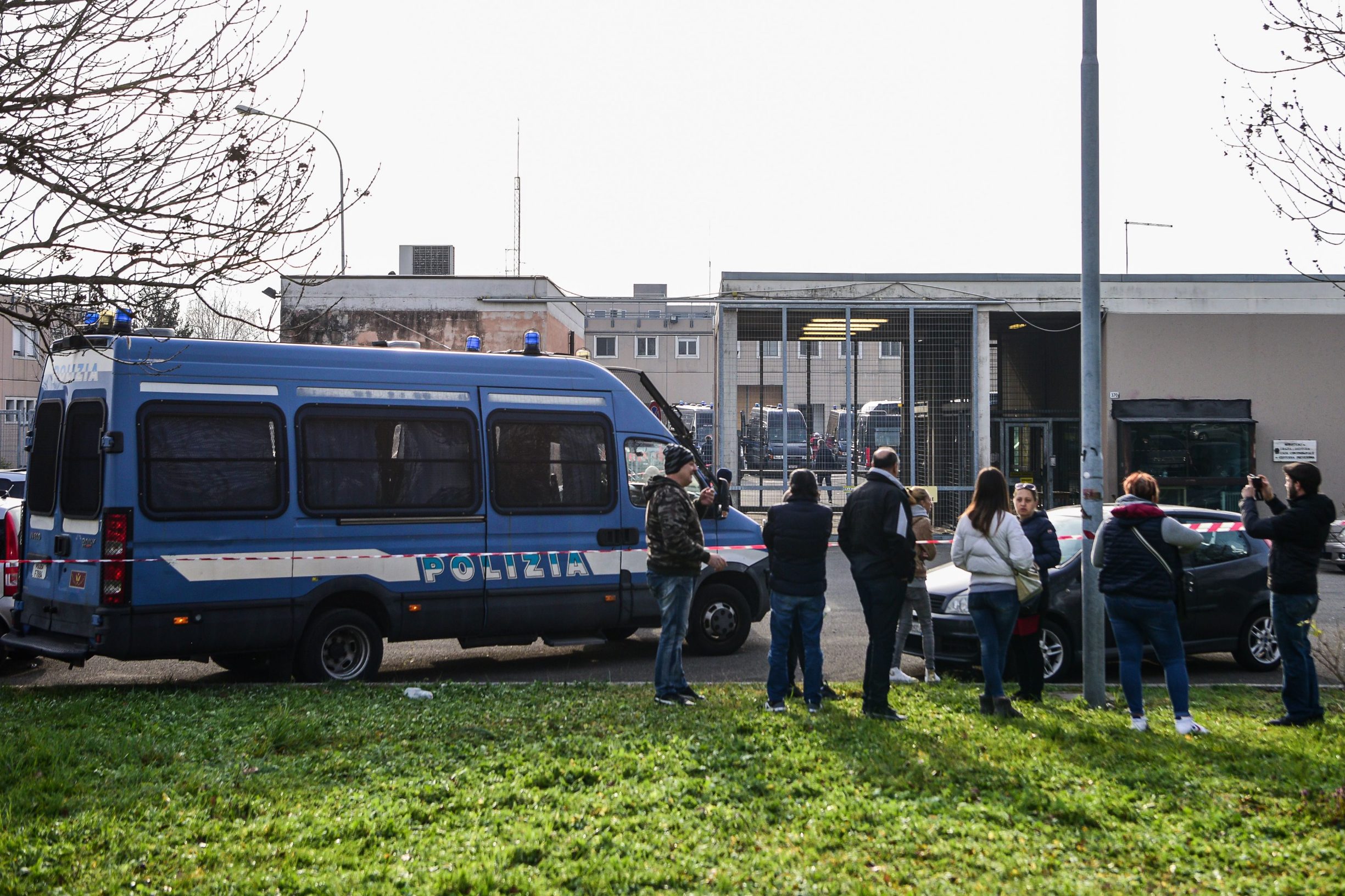 Relatives of inmates gather outside the SantAnna prison in Modena, Emilia-Romagna, in one of Italy's quarantine red zones on March 9, 2020. - Inmates in four Italian prisons have revolted over new rules introduced to contain the coronavirus outbreak, leaving one prisoner dead and others injured, a prison rights group said on March 8. Prisoners at jails in Naples Poggioreale in the south, Modena in the north, Frosinone in central Italy and at Alexandria in the northwest had all revolted over measures including a ban on family visits, unions said. (Photo by Piero CRUCIATTI / AFP)
