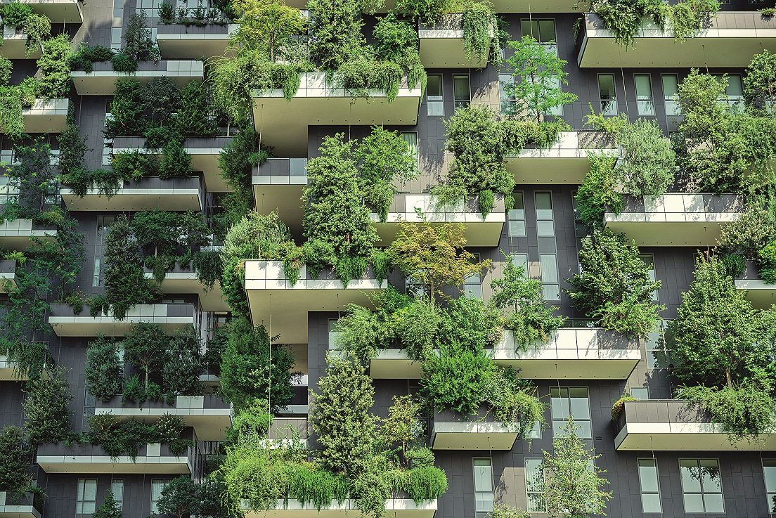 Milan, Italy, High-rise house with trees, shrubs and hedges in the city of Milan.