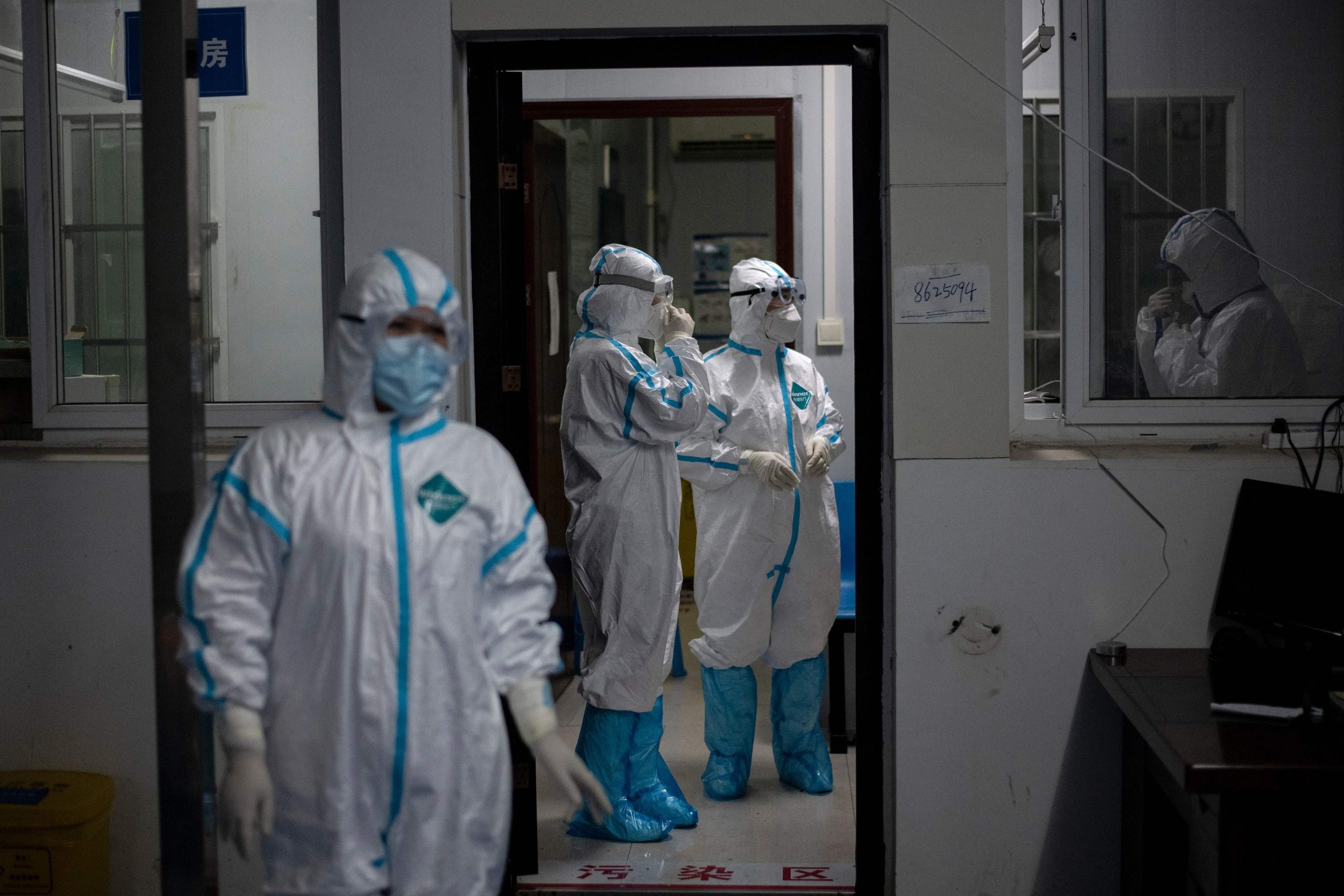 Medical workers wearing hazmat suits as a preventive measure against the COVID-19 coronavirus are seen at a fever clinic in Huanggang Zhongxin Hospital in Huanggang, in Chinas central Hubei province on March 26, 2020. (Photo by NOEL CELIS / AFP)
