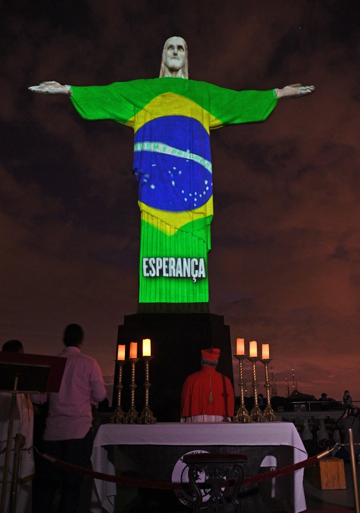 View of the world famous Christ the Redeemer statue on Easter day with A Brazilian flag projected on it and reading �Hope� amid the COVID-9 coronavirus pandemic in Rio de Janeiro, Brazil on April 12, 2020. (Photo by CARL DE SOUZA / AFP)