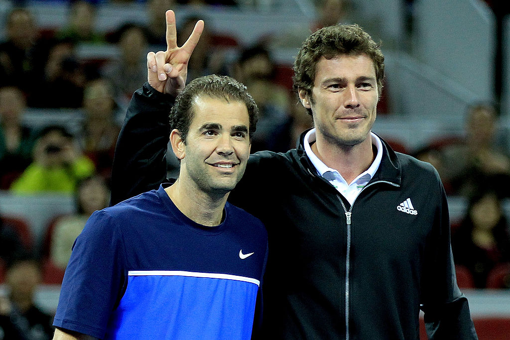 BEIJING, CHINA - SEPTEMBER 30:  Pete Sampras of the United States and Marat Safin of Russia pose for photographers at the net during an exhibition match to inaugurate the opening of the new stadium during the China Open on September 30, 2011 in Beijing, China.  (Photo by Matthew Stockman/Getty Images)