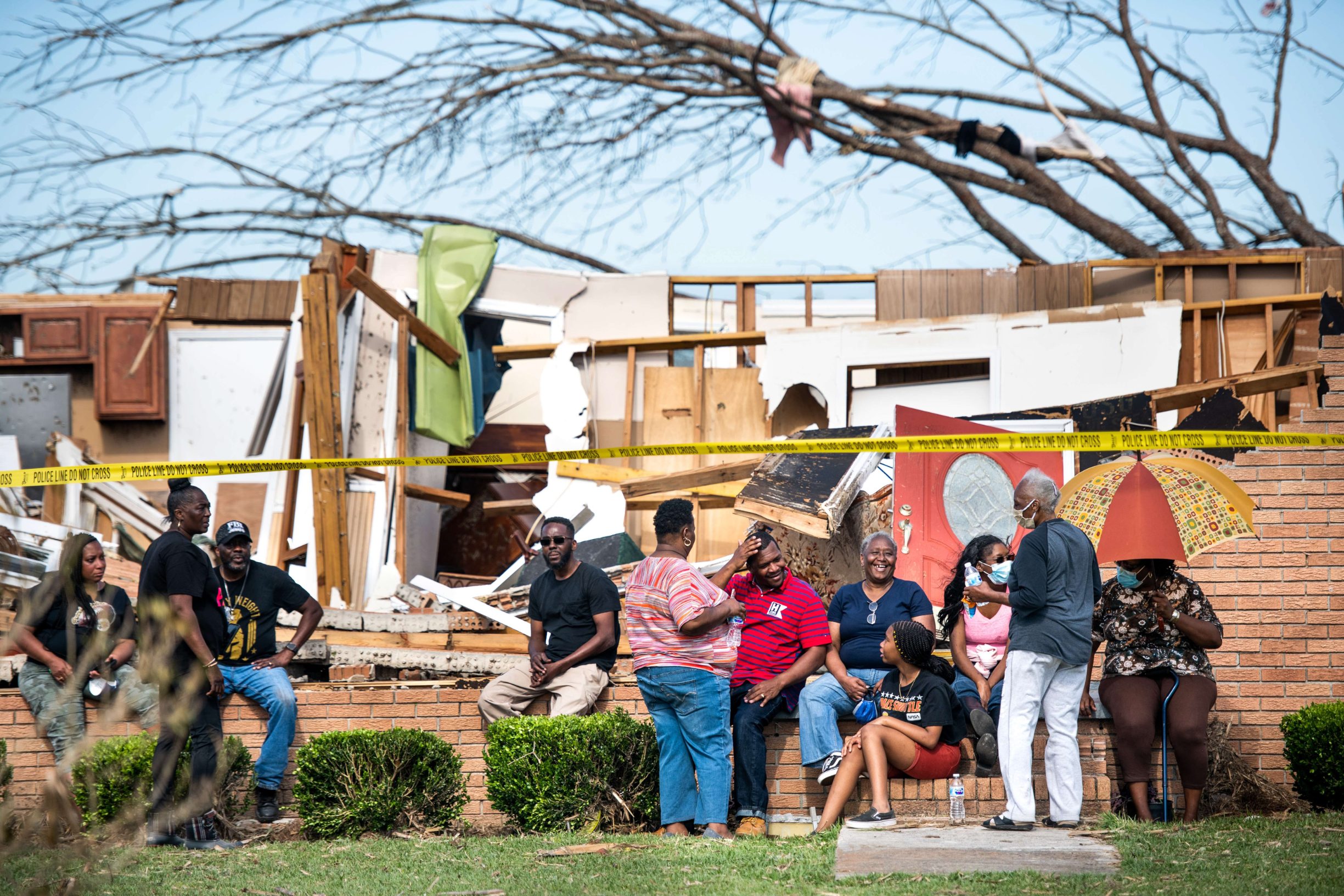 NIXVILLE, SC - APRIL 13: Family, friends and neighbors sit in front of a destroyed home on April 13, 2020 in Nixville, South Carolina. A string of storms across the southern United States that began Easter Sunday and continued into today produced multiple tornados resulting in more than 30 deaths and dozens more injuries.   Sean Rayford/Getty Images/AFP
== FOR NEWSPAPERS, INTERNET, TELCOS & TELEVISION USE ONLY ==