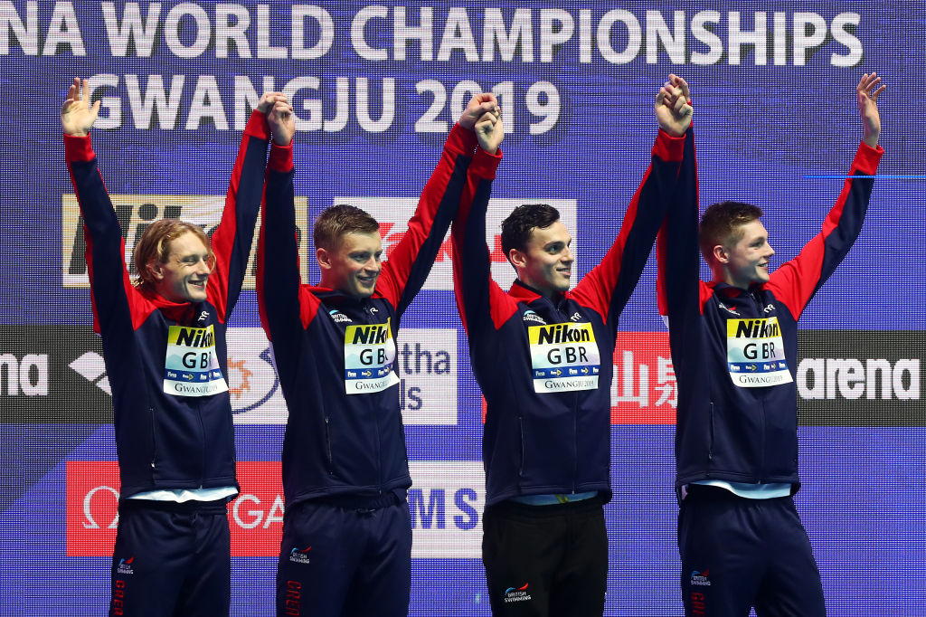 GWANGJU, SOUTH KOREA - JULY 28: Gold medalists Luke Greenbank, Adam Peaty, James Guy and Duncan Scott of Great Britain celebrate on the podium at the medal ceremony for the Men's 4x100m Medley Relay on day eight of the Gwangju 2019 FINA World Championships at Nambu International Aquatics Centre on July 28, 2019 in Gwangju, South Korea. (Photo by Clive Rose/Getty Images)