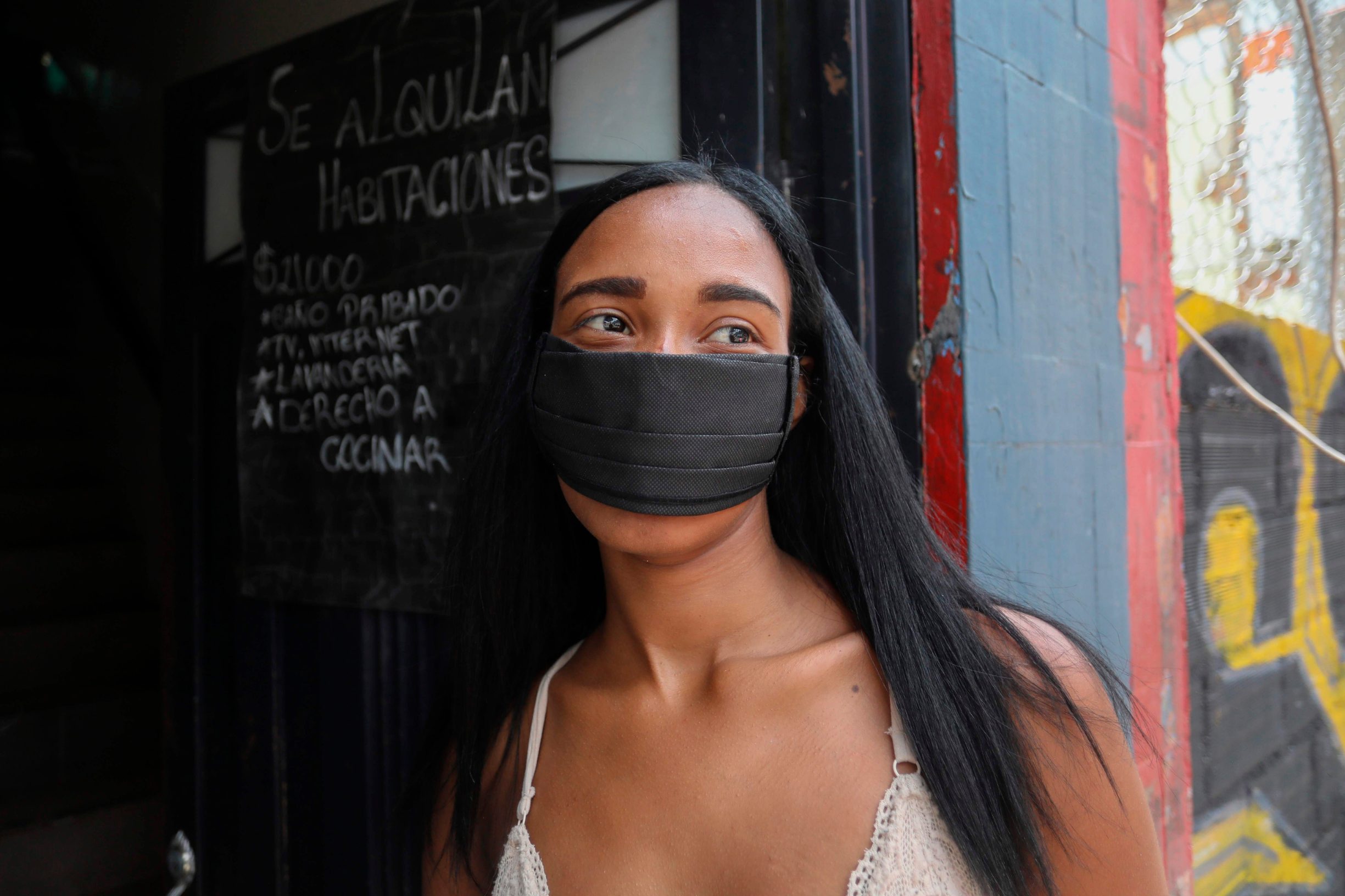 Sex worker Marcela is picture outside a low cost hotel in the Tolerance zone known as the Raudal Sector, where sex workers live and work in Medellin, Colombia, on April 8, 2020. (Photo by Joaquin SARMIENTO / AFP)