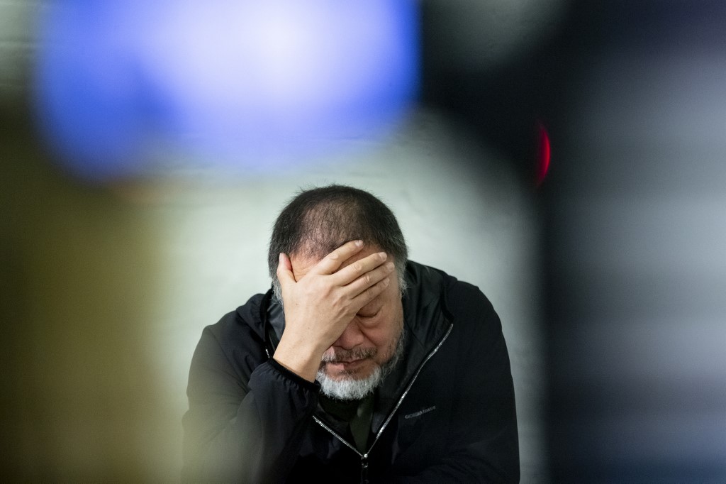 11 February 2020, Berlin: The Chinese artist Ai Weiwei supports his head in one hand when presenting his artwork 
