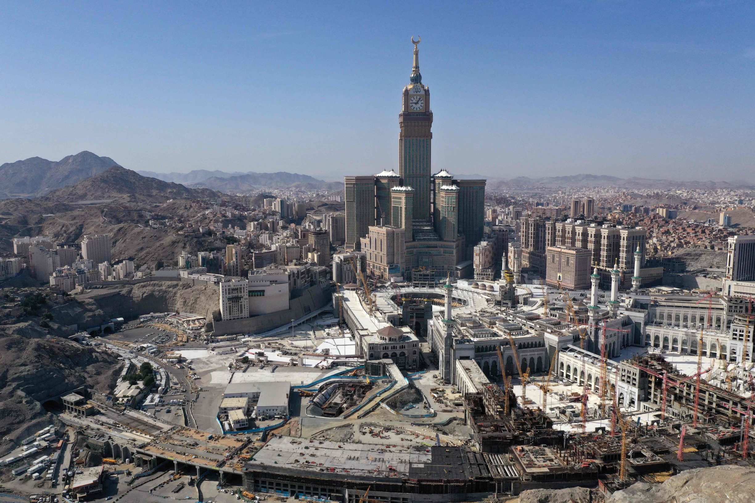 An aerial view shows the Great Mosque and the Mecca Tower and the deserted surroundings in the Saudi holy city of Mecca on April 8, 2020, during the novel coronavirus pandemic crisis. (Photo by BANDAR ALDANDANI / AFP)