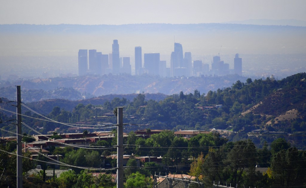 A layer of pollution can be seen hovering over Los Angeles, California on October 17, 2017, where even though air quality has improved in recent decades, smog levels remain among the nations's worst, with wildfires in the region also contributing to poor air quality. (Photo by FREDERIC J. BROWN / AFP)
