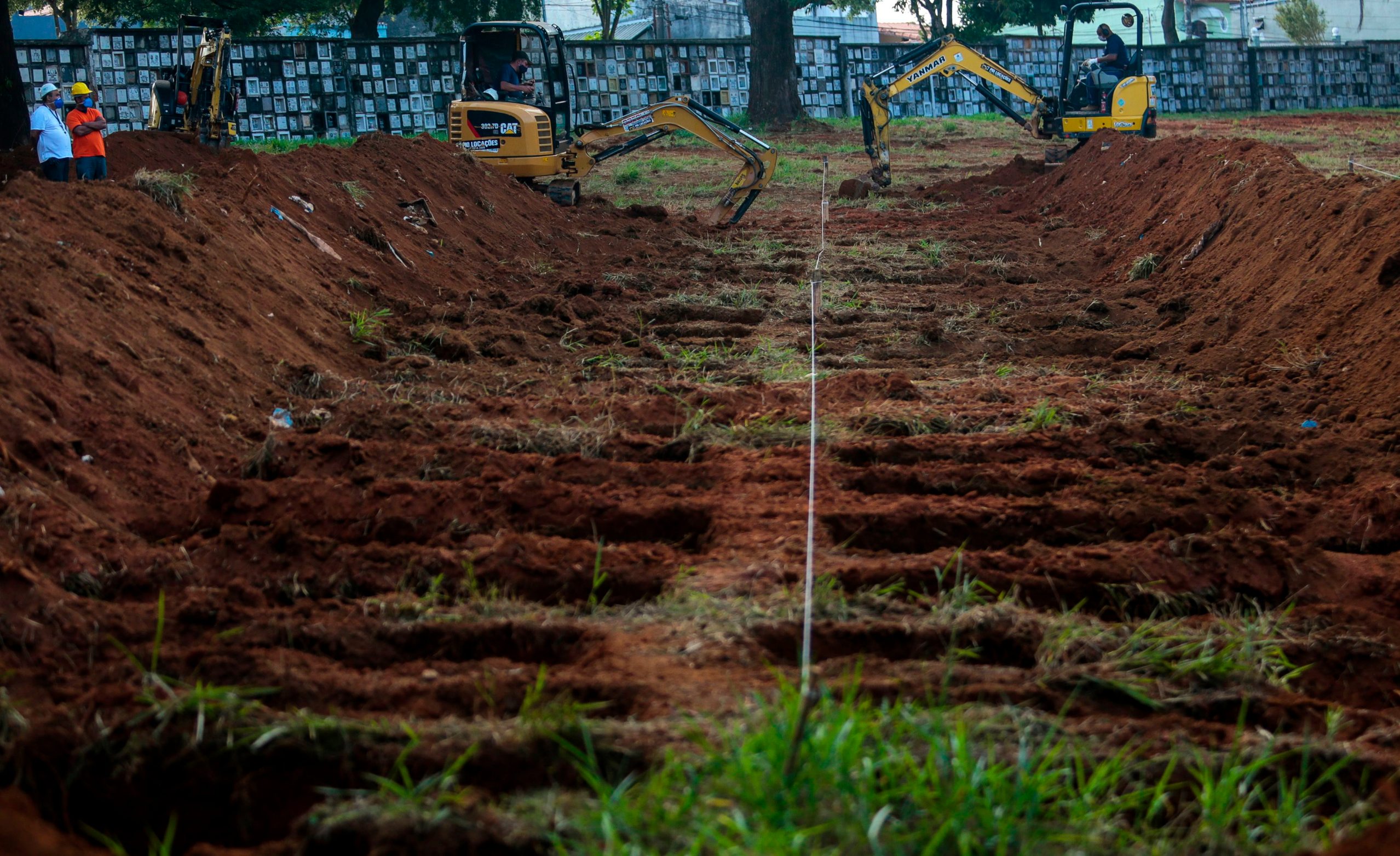Workers dig graves in the Vila Formosa cemetery, due to an expected increase in deaths within the COVID-19 coronavirus pandemic, in the city of Sao Paulo, Brazil, 21 April 2020. (Photo by Miguel SCHINCARIOL / AFP)