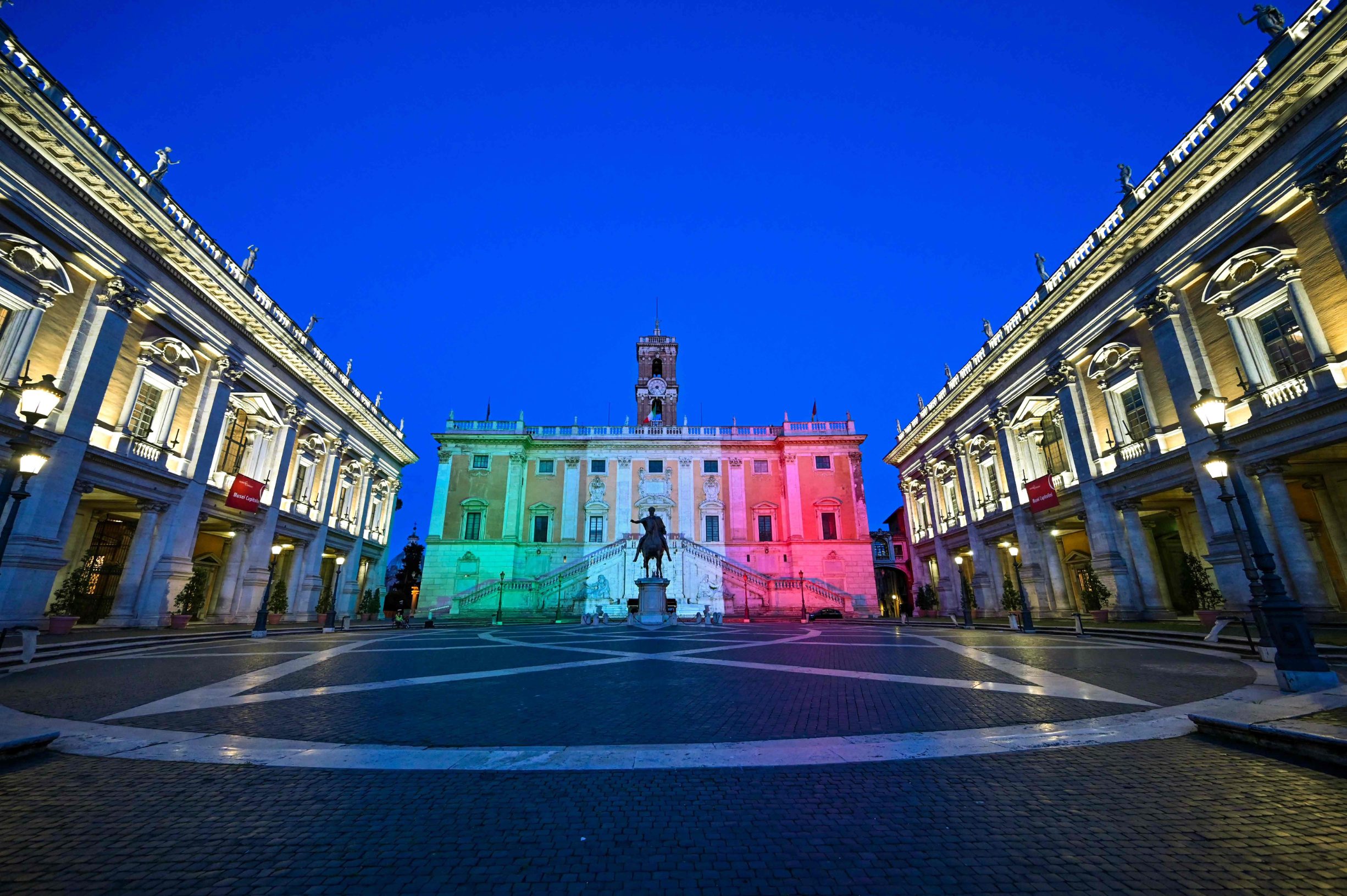 The colors of the Italian flag are projected onto the Palazzo Senatorio building on Capitoline Hill (Campidoglio) in Rome, on April 26, 2020 during the country's lockdown aimed at curbing the spread of the COVID-19 infection, caused by the novel coronavirus. (Photo by ANDREAS SOLARO / AFP)