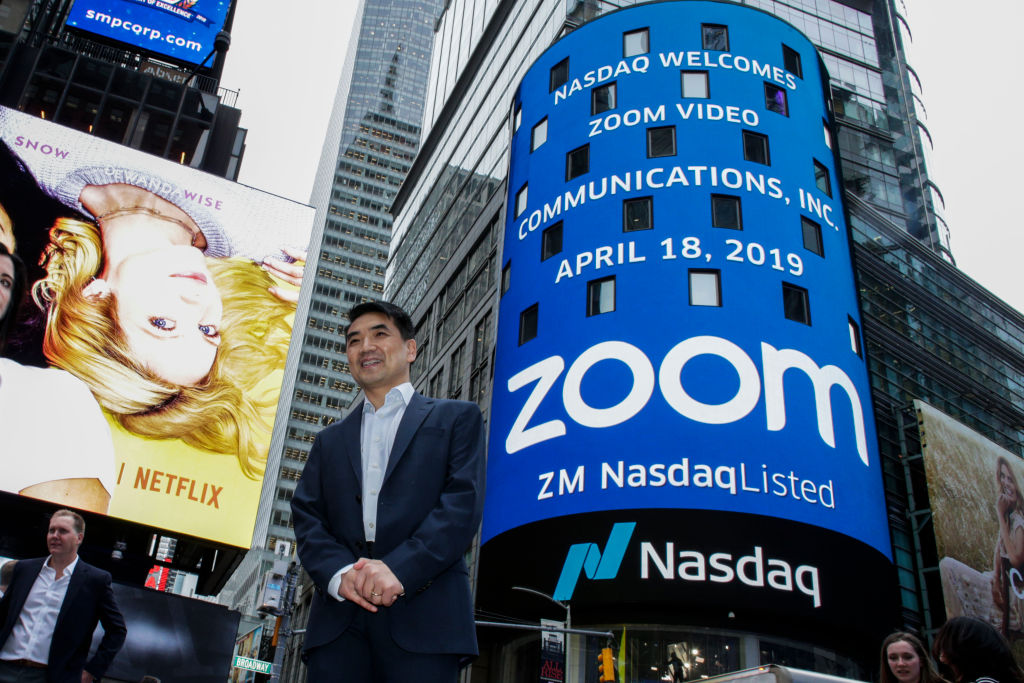 NEW YORK, NY - APRIL 18: Zoom founder Eric Yuan poses in front of the Nasdaq building as the screen shows the logo of the video-conferencing software company Zoom after the opening bell ceremony on April 18, 2019 in New York City. The video-conferencing software company announced it's IPO priced at  per share, at an estimated value of .2 billion. (Photo by Kena Betancur/Getty Images)