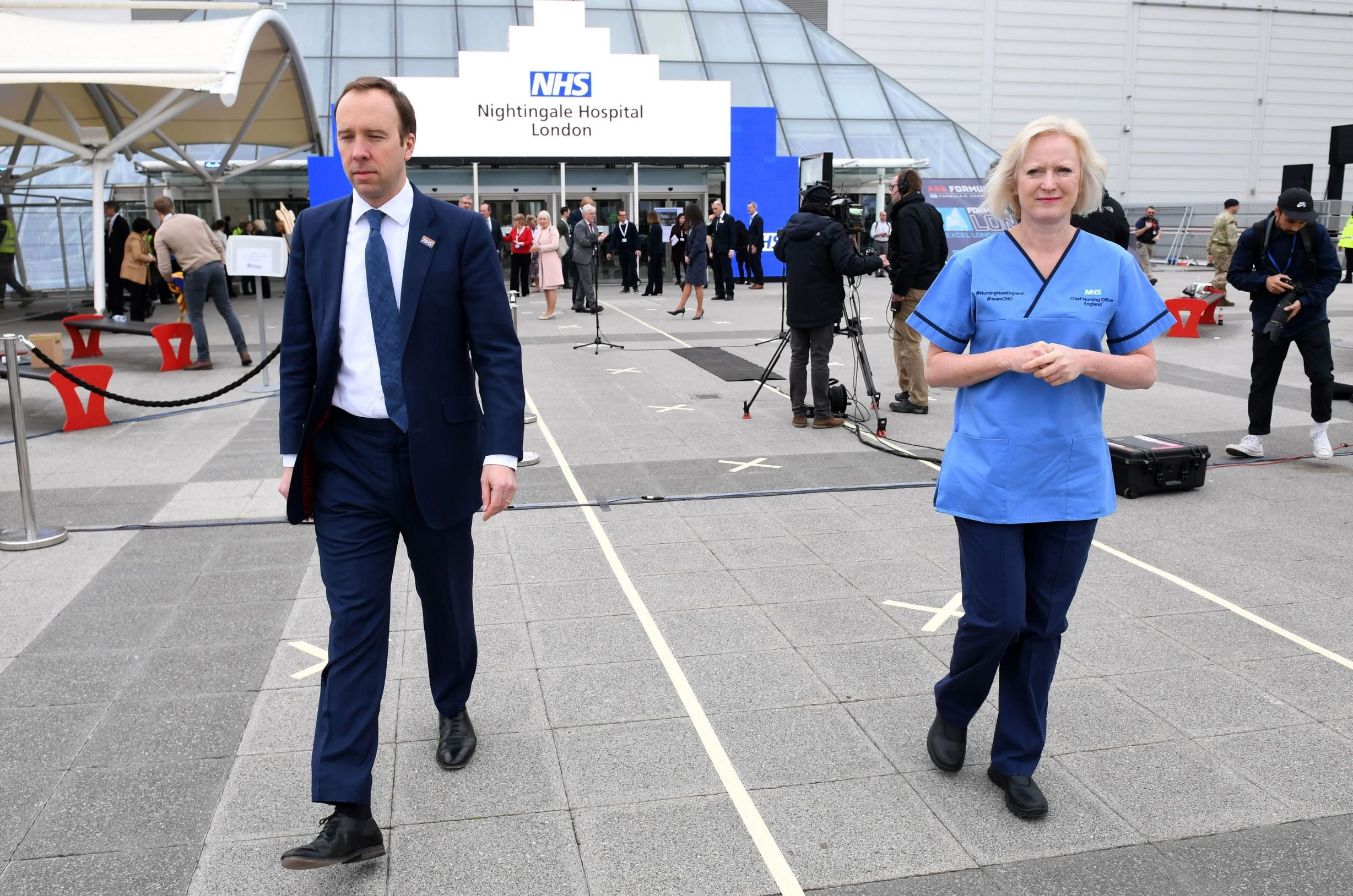 Britain's Health Secretary Matt Hancock (L) and chief nursing officer for England, Ruth May attend the opening of the 