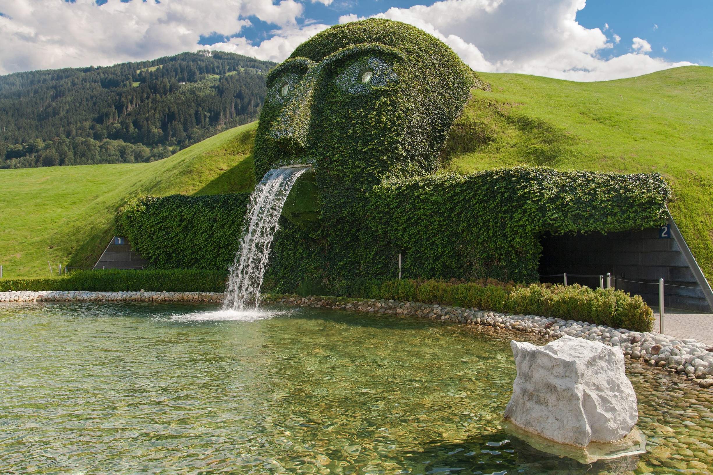 Wattens, Austria - August 18, 2011: The Giant, waterspout and fountain at the entrance of Swarovski Kristallwelten in Wattens, Austria.