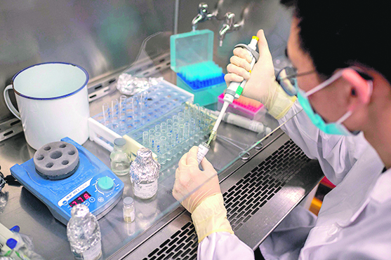 In this picture taken on April 29, 2020, an engineer works at the Quality Control Laboratory on an experimental vaccine for the COVID-19 coronavirus at the Sinovac Biotech facilities in Beijing. - Sinovac Biotech, which is conducting one of the four clinical trials that have been authorised in China, has claimed great progress in its research and promising results among monkeys. (Photo by NICOLAS ASFOURI / AFP) / TO GO WITH Health-virus-China-vaccine,FOCUS by Patrick Baert