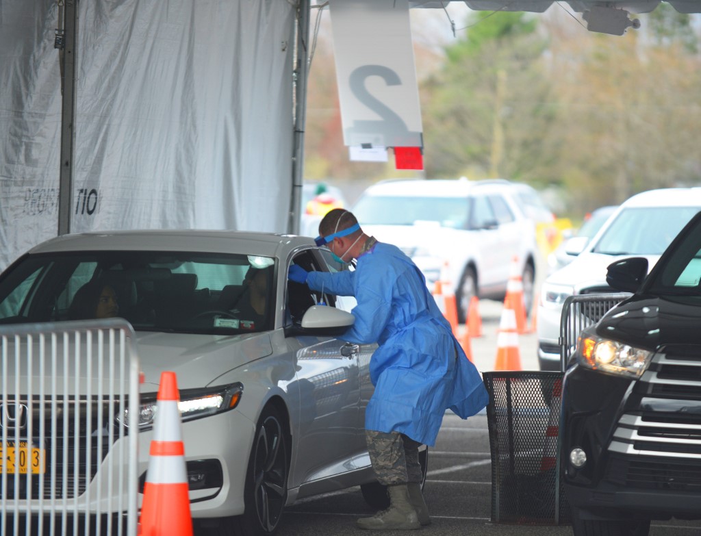 Medical professionals from the NYC Joint Task Force consisting of Army, Navy, Air Force and Marine Corps personnel administer COVID-19 tests at the drive-through COVID-19 testing center and field ER at Stony Brook, New York. The facility is scheduled to test 979 suspected coronavirus victims today, on April 4, 2020. (Photo by B.A. Van Sise/NurPhoto)