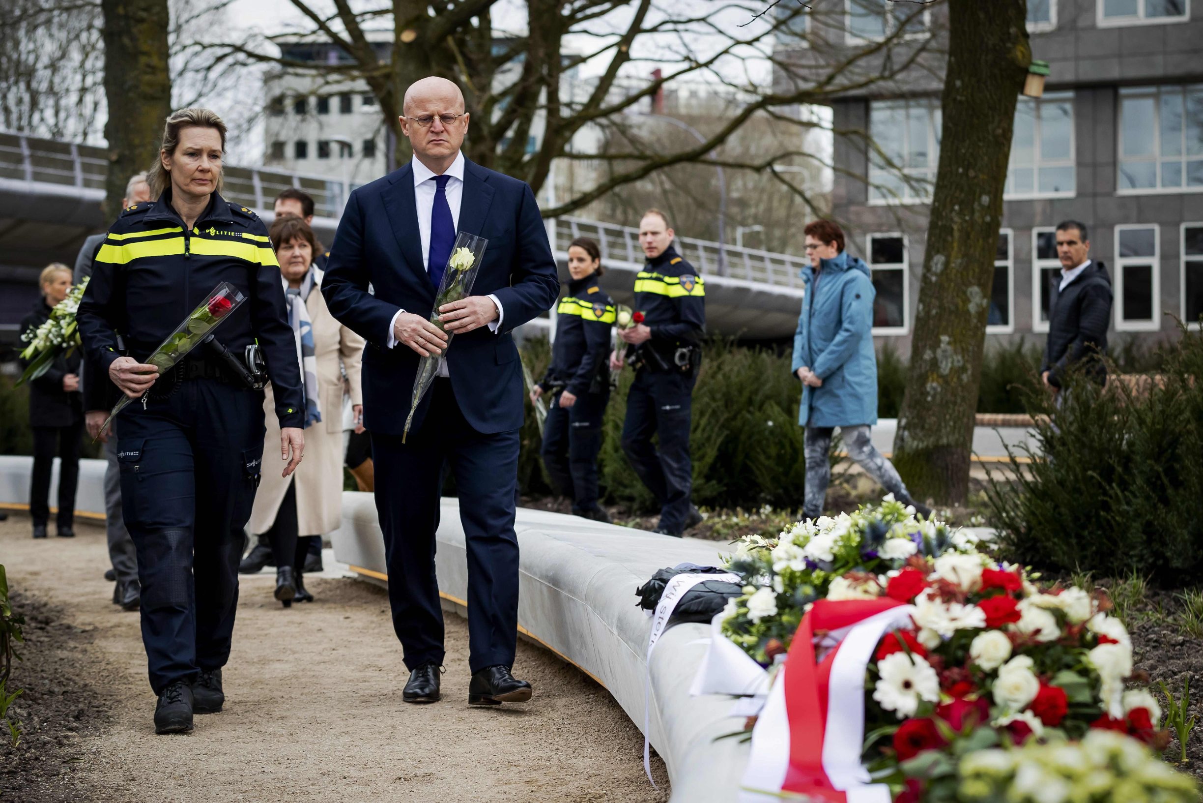 Dutch Minister of Justice and Security Ferdinand Grapperhaus (R) arrives  to pay a tribute at the 24th October Square in Utrecht, on March 18, 2020, a year after a tram attack which killed four people took place. (Photo by Robin VAN LONKHUIJSEN / ANP / AFP) / Netherlands OUT