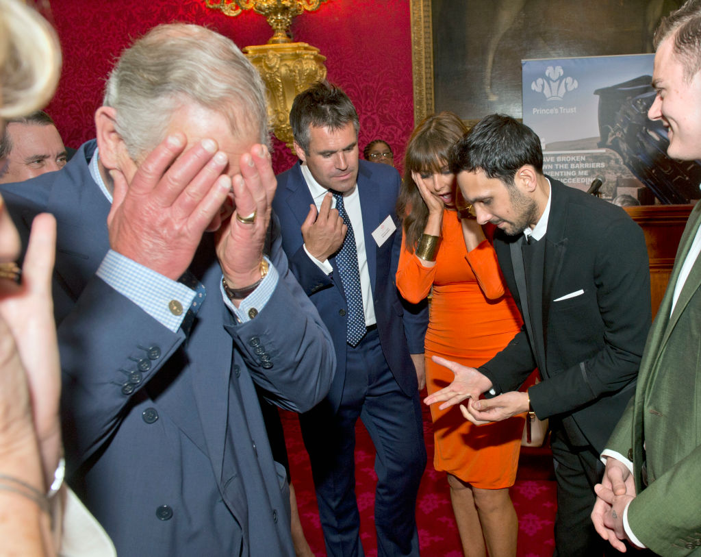 LONDON, UNITED KINGDOM - JUNE 20:   Prince Charles, Prince of Wales (L) reacts as magician Dynamo (2nd R) demonstrates the flexibility of his fingers as Kenny Logan and Carol Voderman look on at a reception for the Prince's Trust Job Ambassadors to mark the appointment of one hundred Job Ambassadors at Clarence House on June 20, 2013 in London, England.  (Photo by Arthur Edwards - Pool/Getty Images)