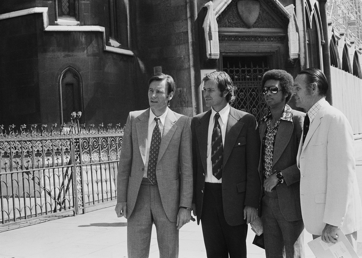 Croatian tennis player Nikola Pilic (far left), outside the High Court in London with (left to right) tennis players Cliff Drysdale, Arthur Ashe (1943 - 1993) and Jack Kramer, 18th June 1973. They are awaiting a judgement on an application by the Association of Tennis Professionals (ATP) for an injunction seeking to lift the ban placed on Pilic by the International Tennis Federation. The suspension on Pilic was later upheld and the ATP, led by Kramer, organized a boycott of the 1973 Wimbledon championships by 81 players. (Photo by Leonard Burt/Central Press/Hulton Archive/Getty Images)