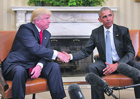 (FILES) In this file photo US President Barack Obama and President-elect Donald Trump shake hands during a  transition planning meeting in the Oval Office at the White House in Washington, DC. - President Donald Trump broke with tradition on May 14 by calling for investigation of his White House predecessor Barack Obama in the latest attempt to push a conspiracy theory about his Democratic opponents. (Photo by JIM WATSON / AFP)